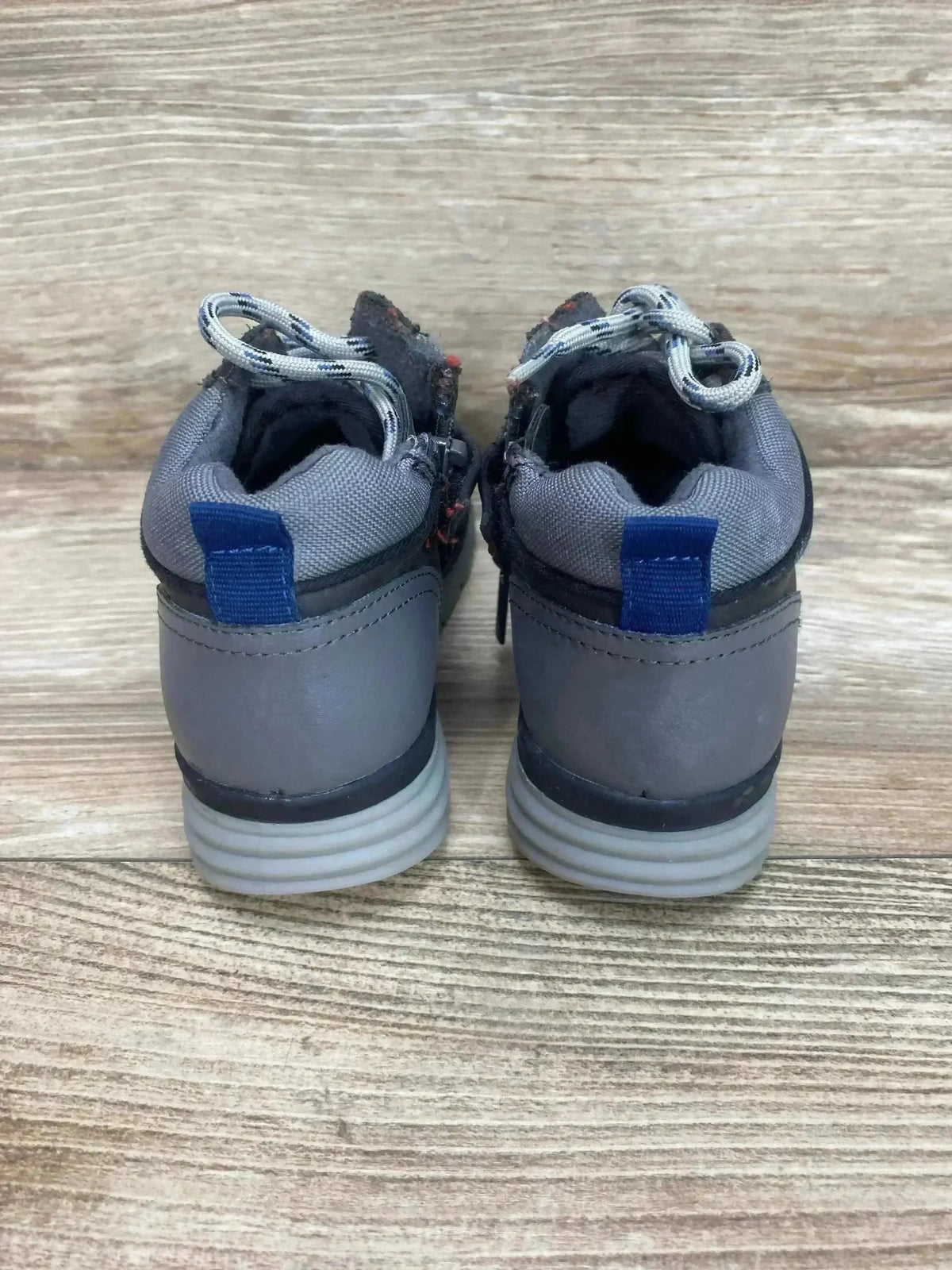 Rear view of Mayoral Colorblock City toddler sneakers, gray, size 12C, showing blue heel pull tabs and ribbed light-gray soles on wood floor