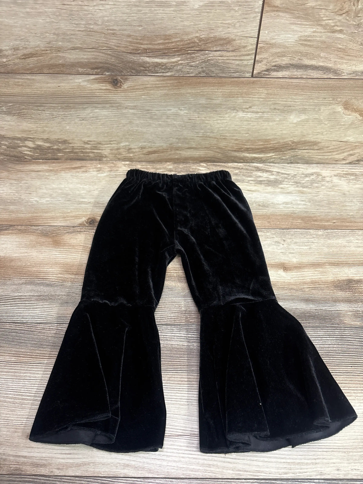 Black velvet bell bottom pants for toddlers by Me n Mommy To Be on a wood background