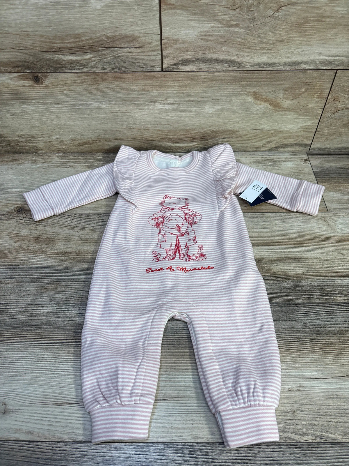 Front view of Baby Gap Paddington VintageSoft footless coverall showcasing pink stripes, ruffle sleeves, and Paddington graphic