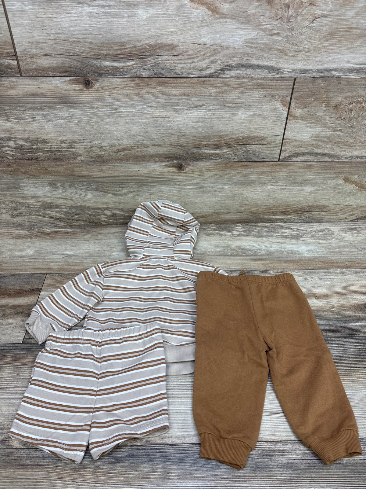 Top-down view of RZ by Rachel Zoe three-piece toddler set showing a striped hooded jacket and shorts with tan joggers