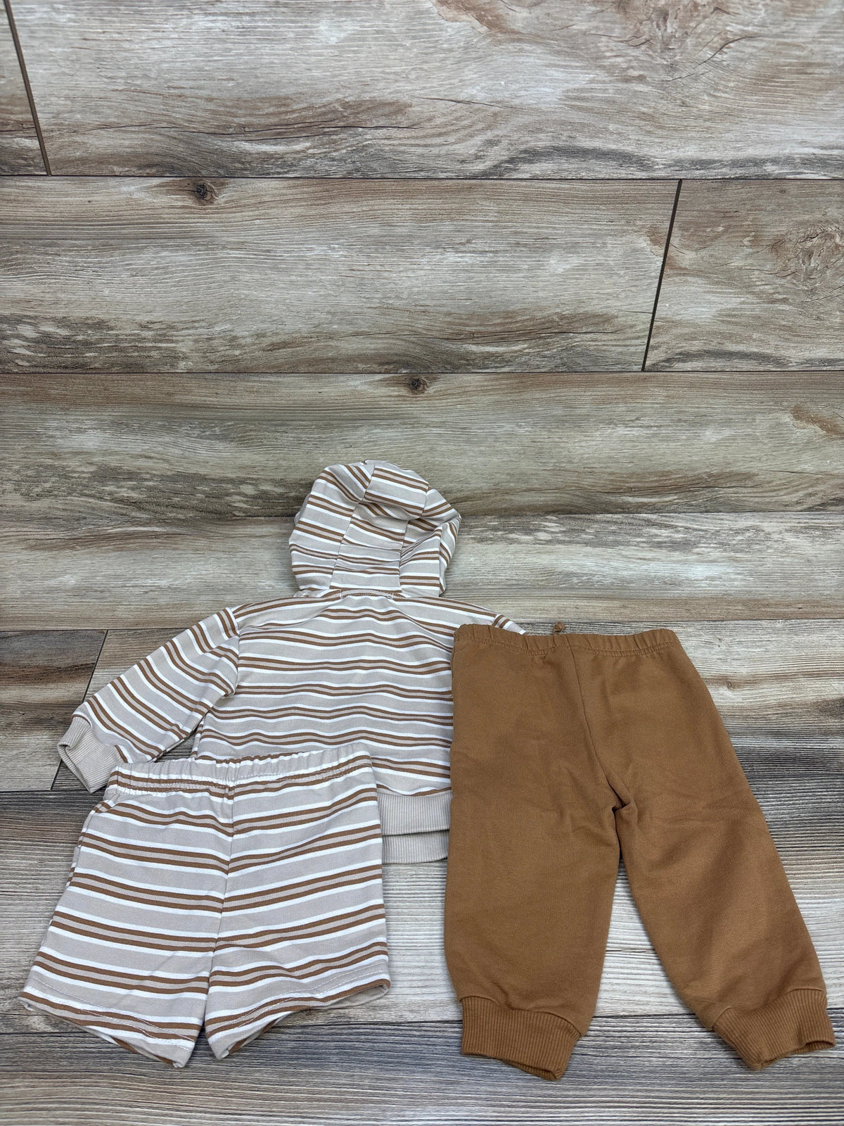 Top-down view of RZ by Rachel Zoe three-piece toddler set showing a striped hooded jacket and shorts with tan joggers