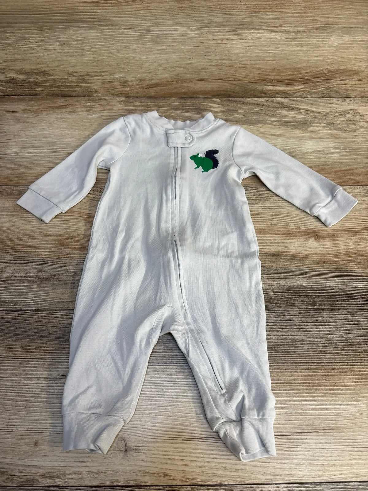 White baby onesie with green squirrel graphic, long-sleeve zip-front sleeper for infants