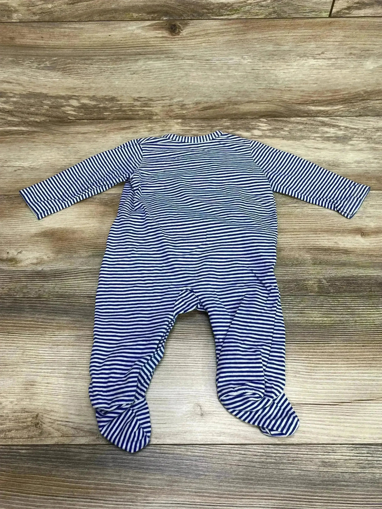 Back view of striped footed coverall size 3 to 6 months showing long sleeves and enclosed feet on wood floor background