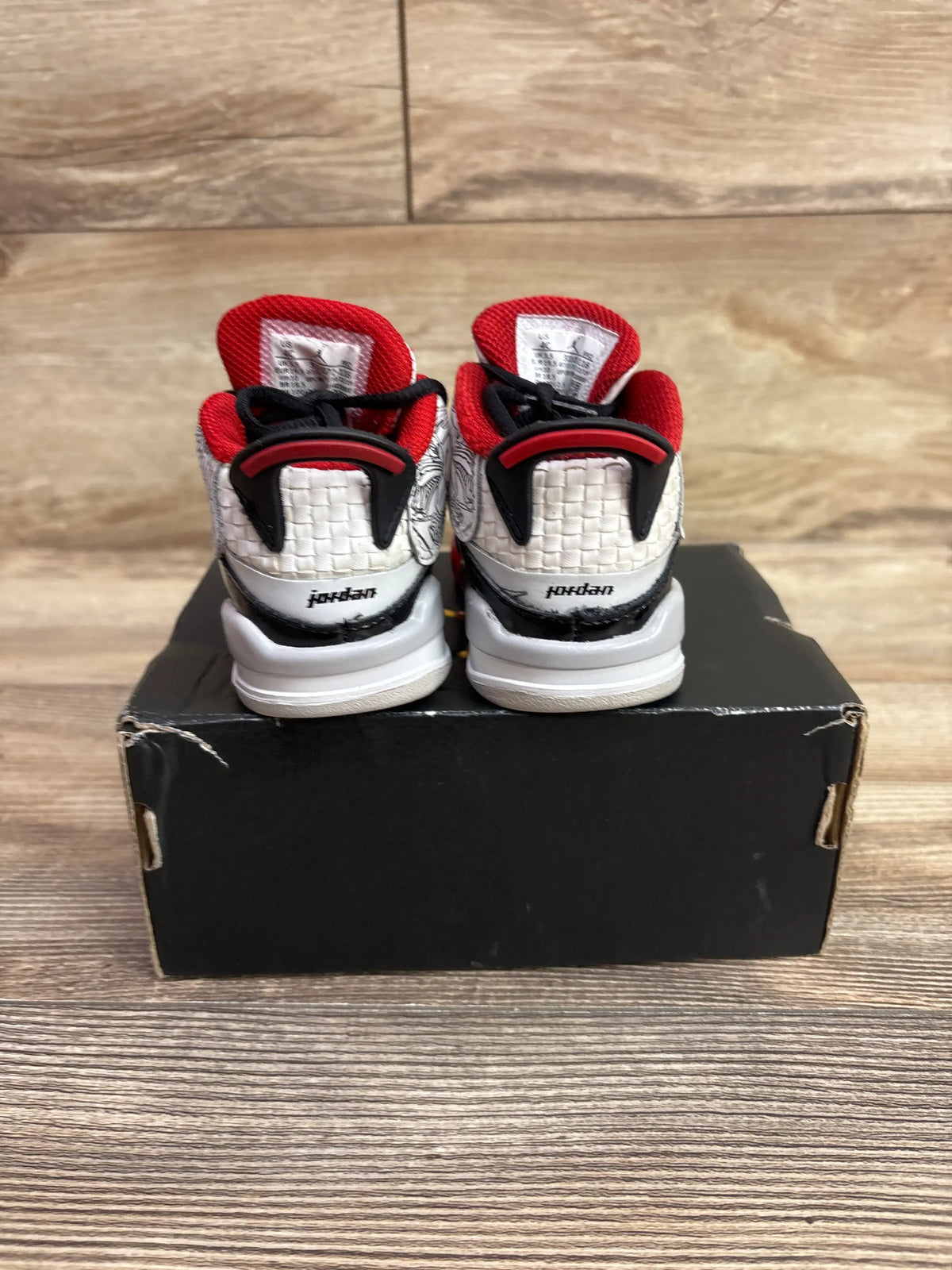 Rear view of Air Jordan Dub Zero TD Varsity Red sneakers in size 4C, showing red, white, and black details on a black shoebox