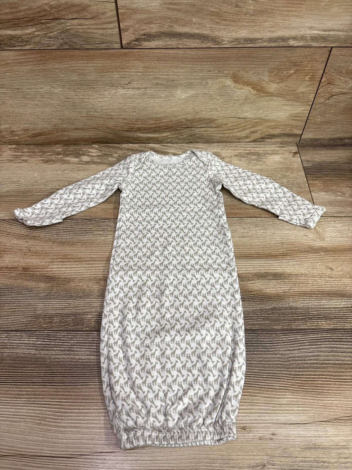 Simple Joys white newborn sleep gown with a small grey pattern on a wooden background