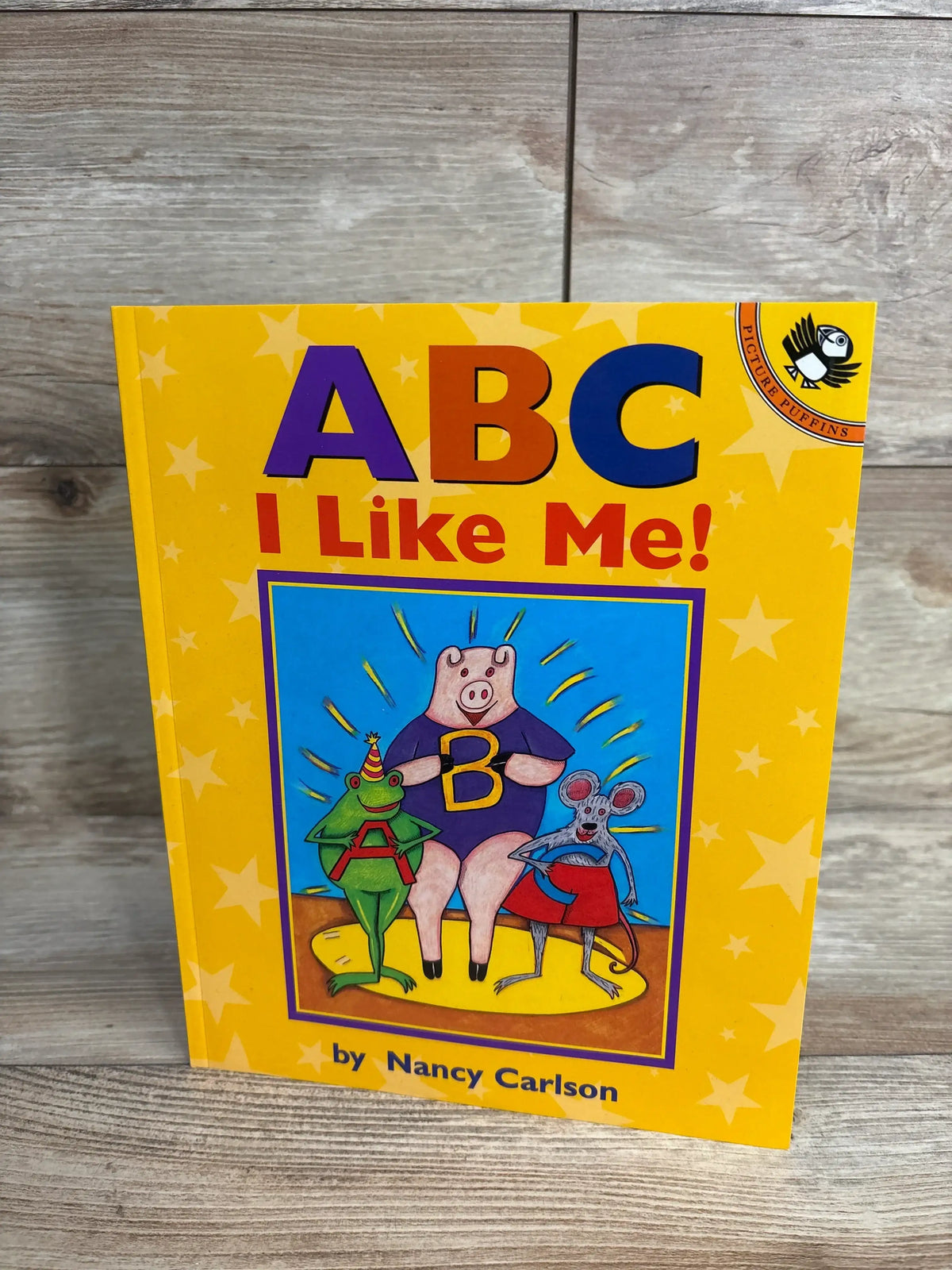 ABC I Like Me! children's book by Nancy Carlson with colorful animal characters on yellow star background