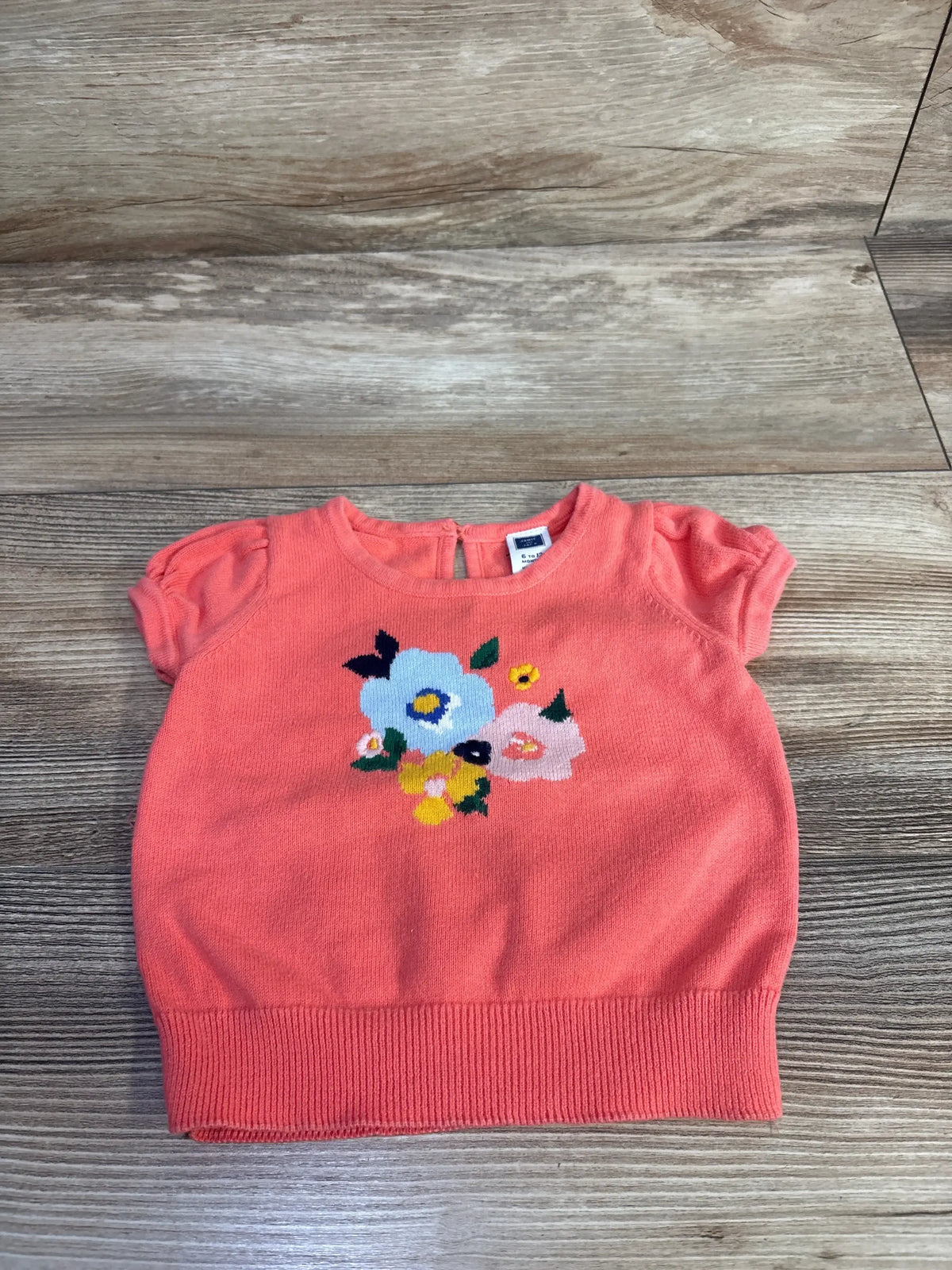 Front view of Janie & Jack girls’ short-sleeve floral sweater in coral, size 6–12 months, on white background