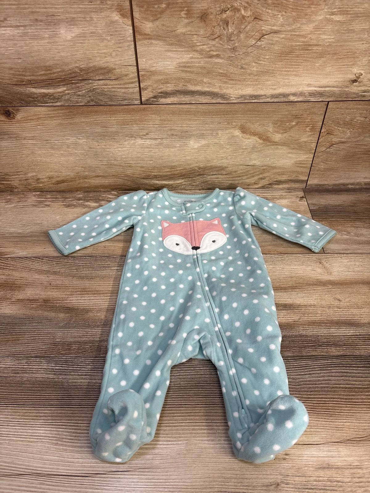 Front view of teal Simple Joys blanket sleeper showcasing white polka dots, fox graphic, and footed design on wood floor