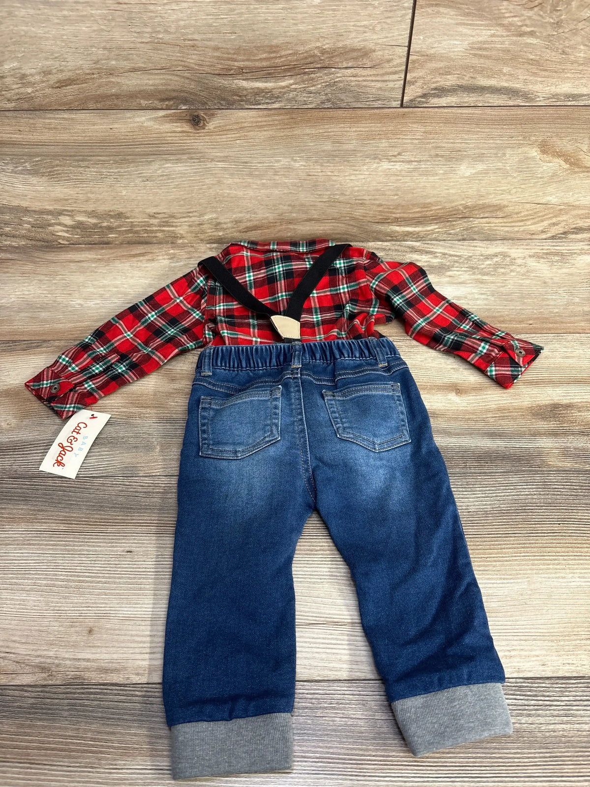 Red plaid baby shirt with denim suspenders and jeans, perfect for festive occasions