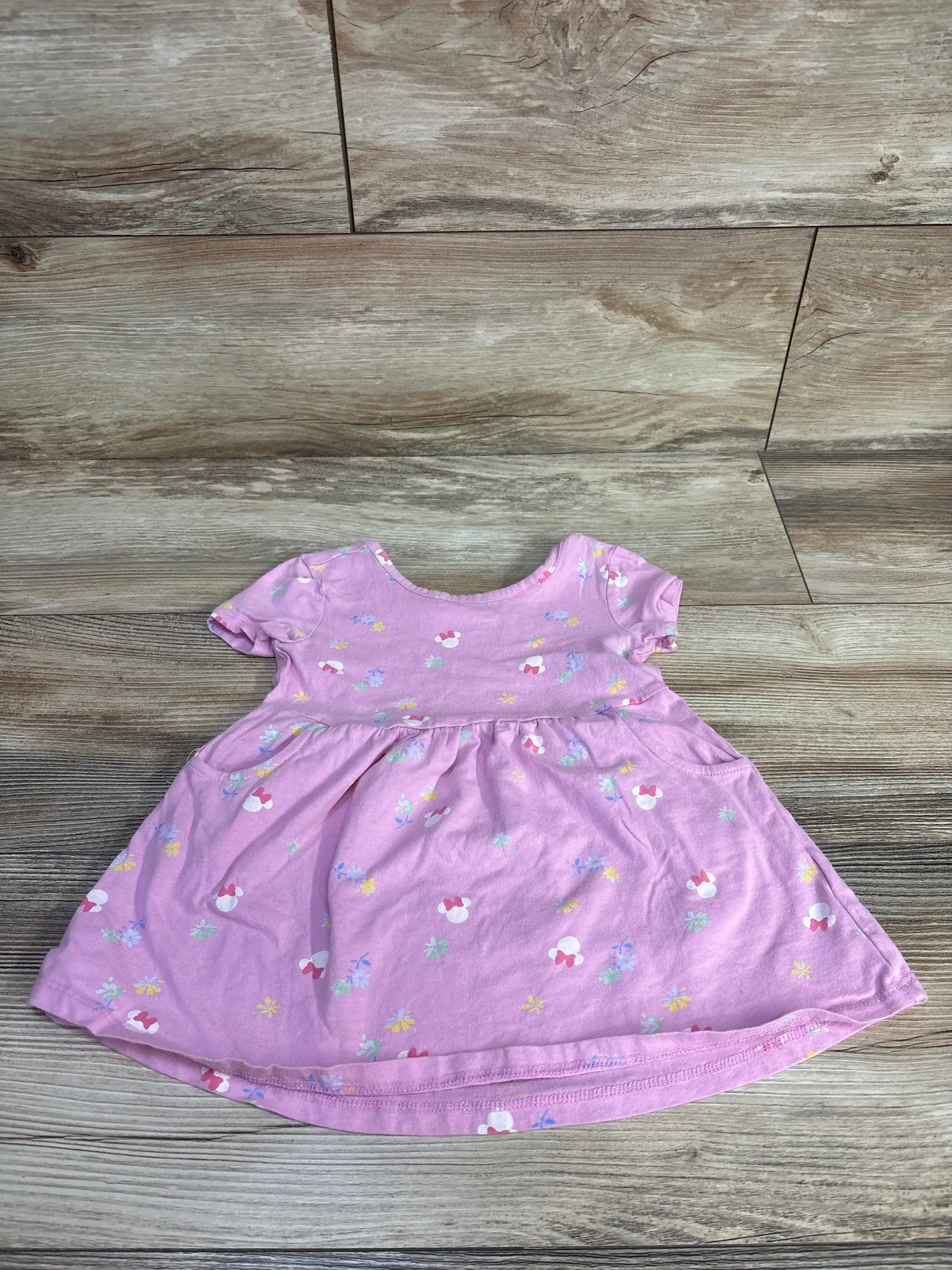 Front view of Baby Gap x Disney Mix & Match Minnie Mouse dress showcasing pink knit fabric and allover Minnie Mouse print