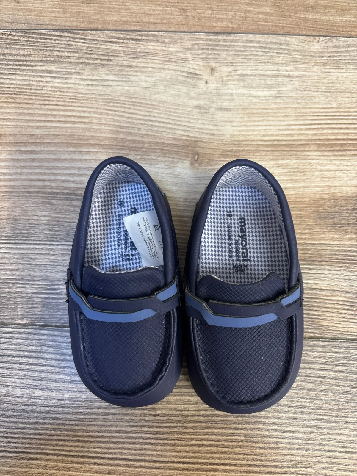 Top view of Mayoral soft-sole navy toddler loafers (size 3/4C) showcasing textured upper and decorative strap on wooden floor
