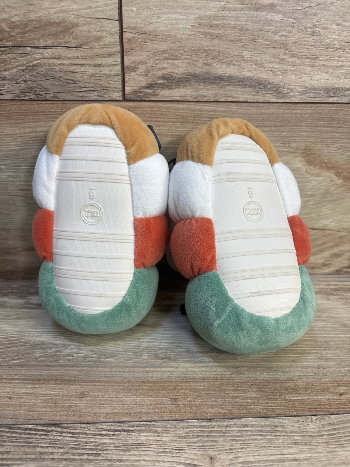 Soft toddler slippers with colorful plush design, perfect for little feet comfort and play.