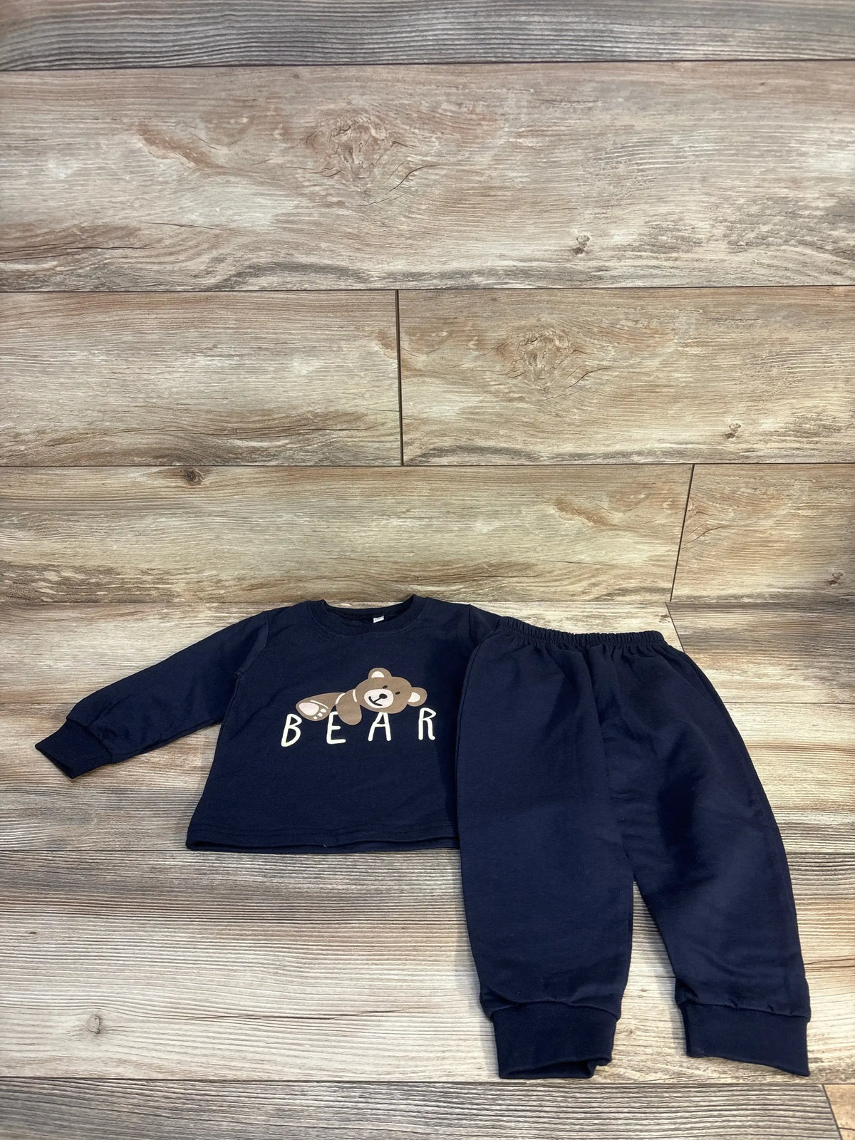 Navy baby bear print long sleeve top and pants set on wood floor