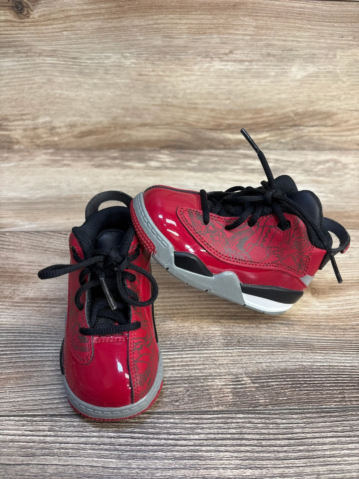 Front and side of Air Jordan Dub Zero TD Toro Bravo toddler sneakers size 6C, glossy red upper, grey midsole, black laces