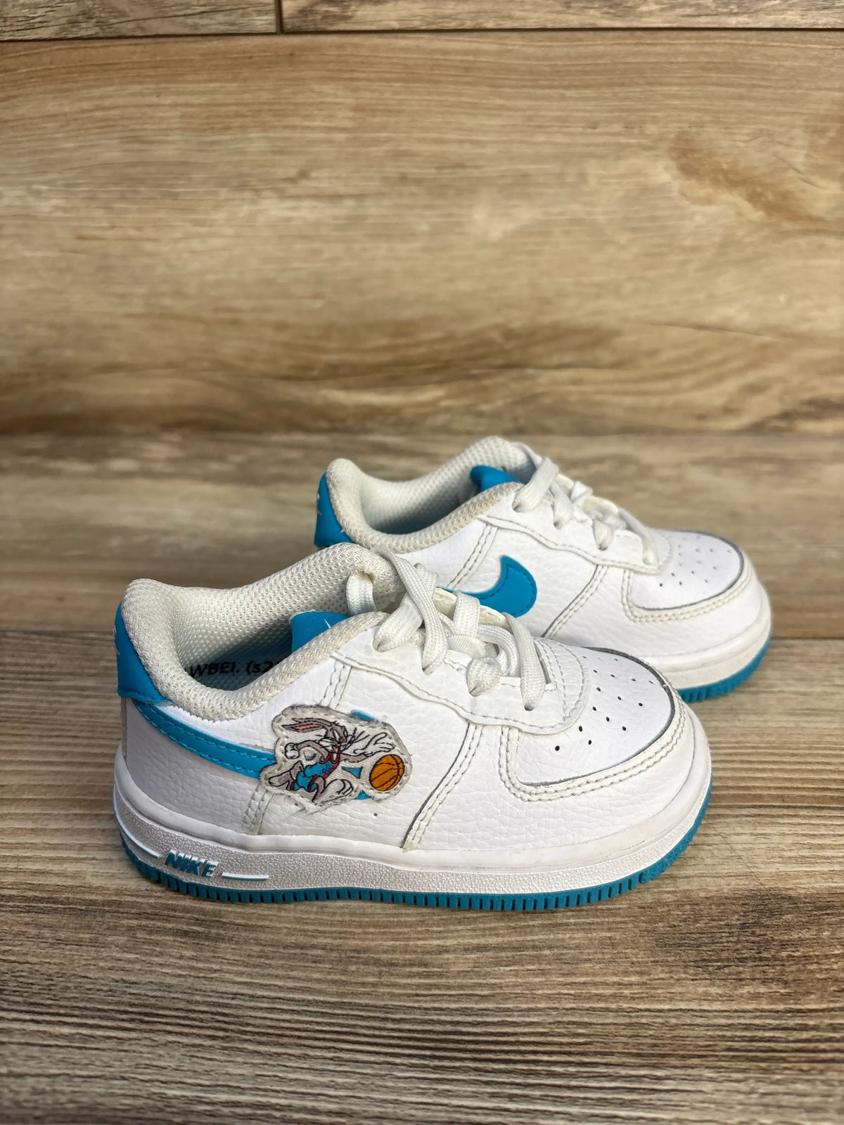 Side view of Nike Air Force 1 TD x Space Jam Hare sneakers showcasing white leather, blue accents, and Bugs Bunny patch