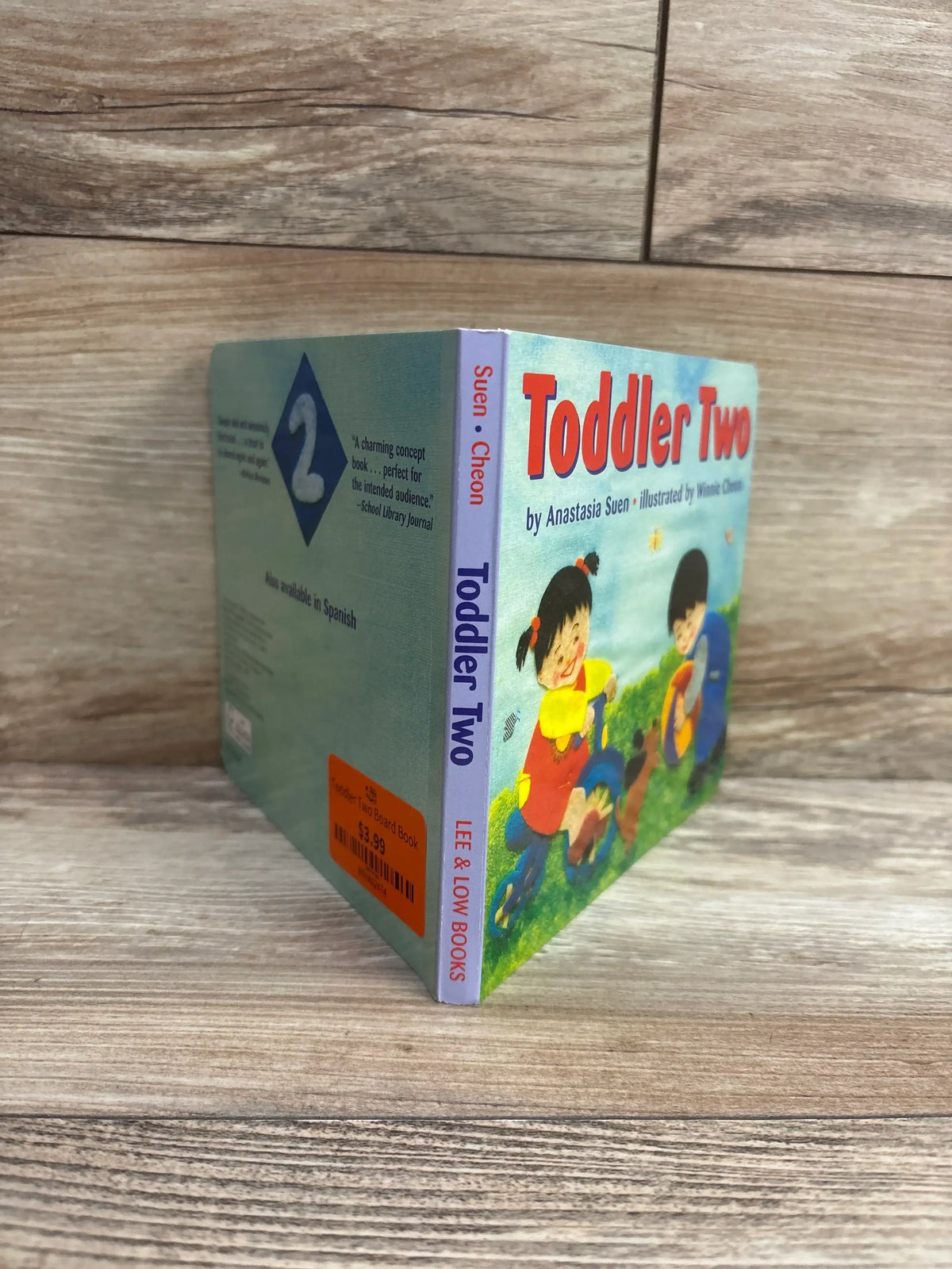 Toddler Two board book by Anastasia Suen displayed on wood background, ideal for young kids