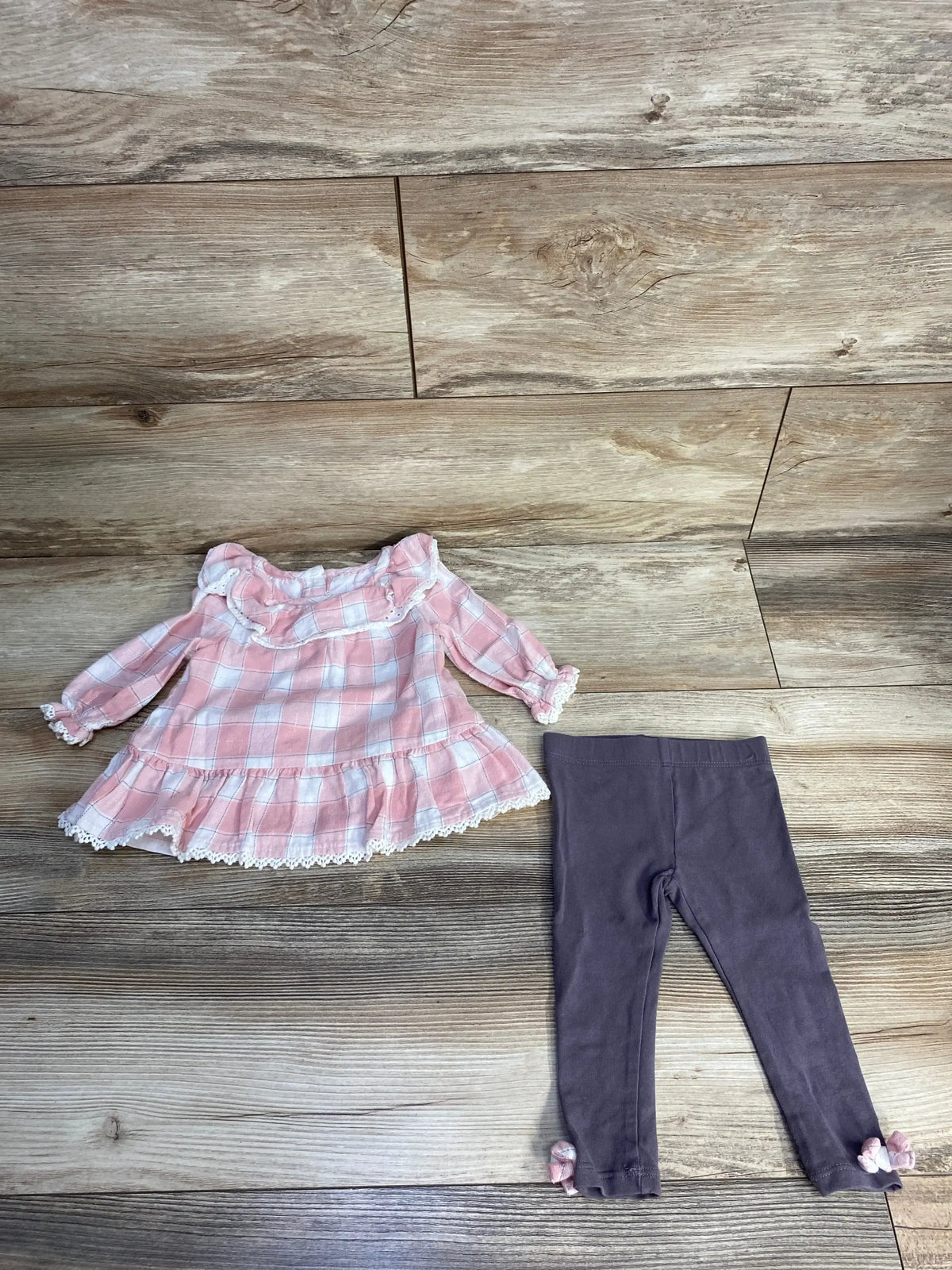 Pink plaid dress with lace trim and gray leggings for toddlers on wooden floor