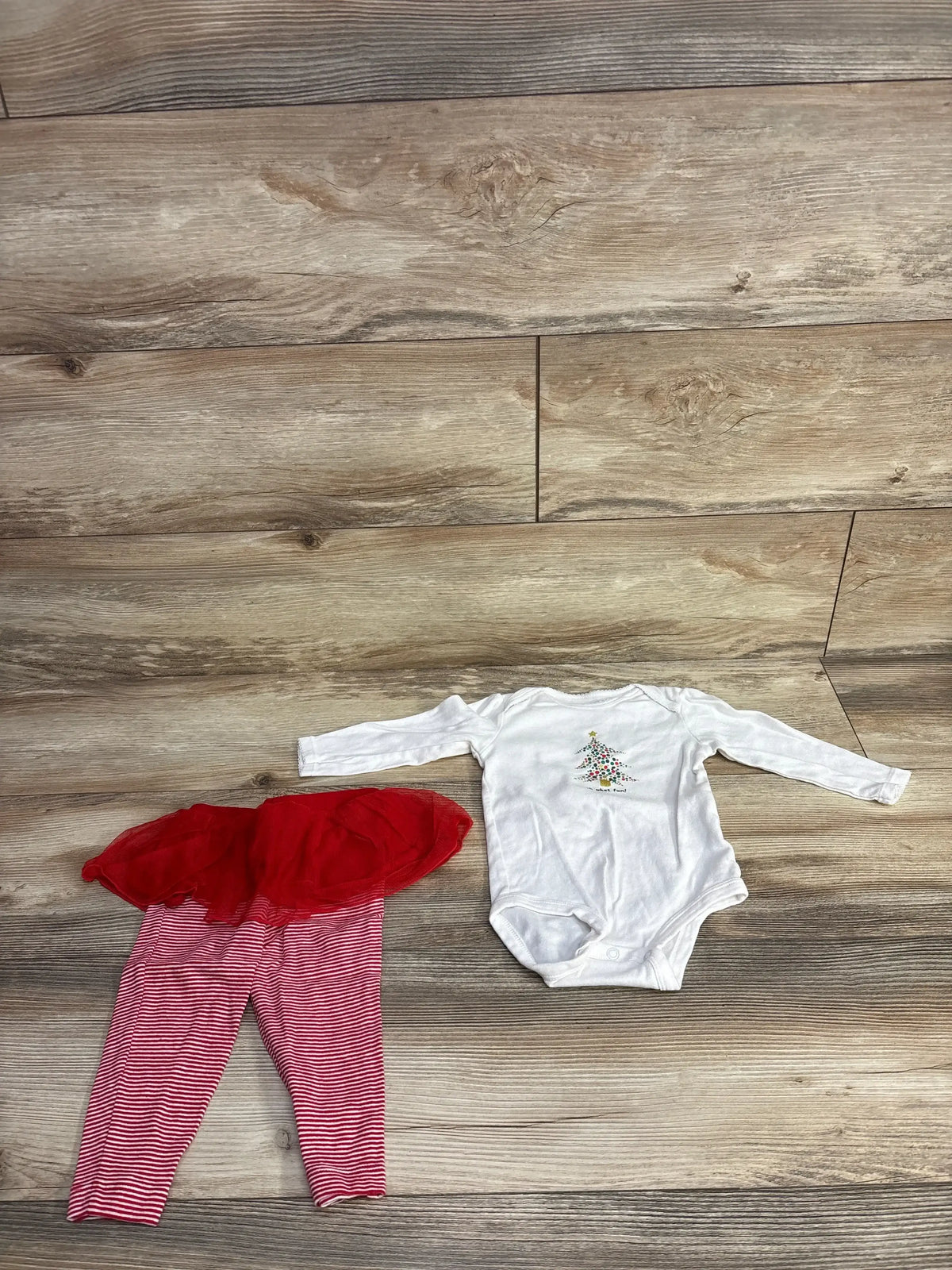 White Christmas tree onesie with red striped tutu pants, baby holiday outfit on wood floor