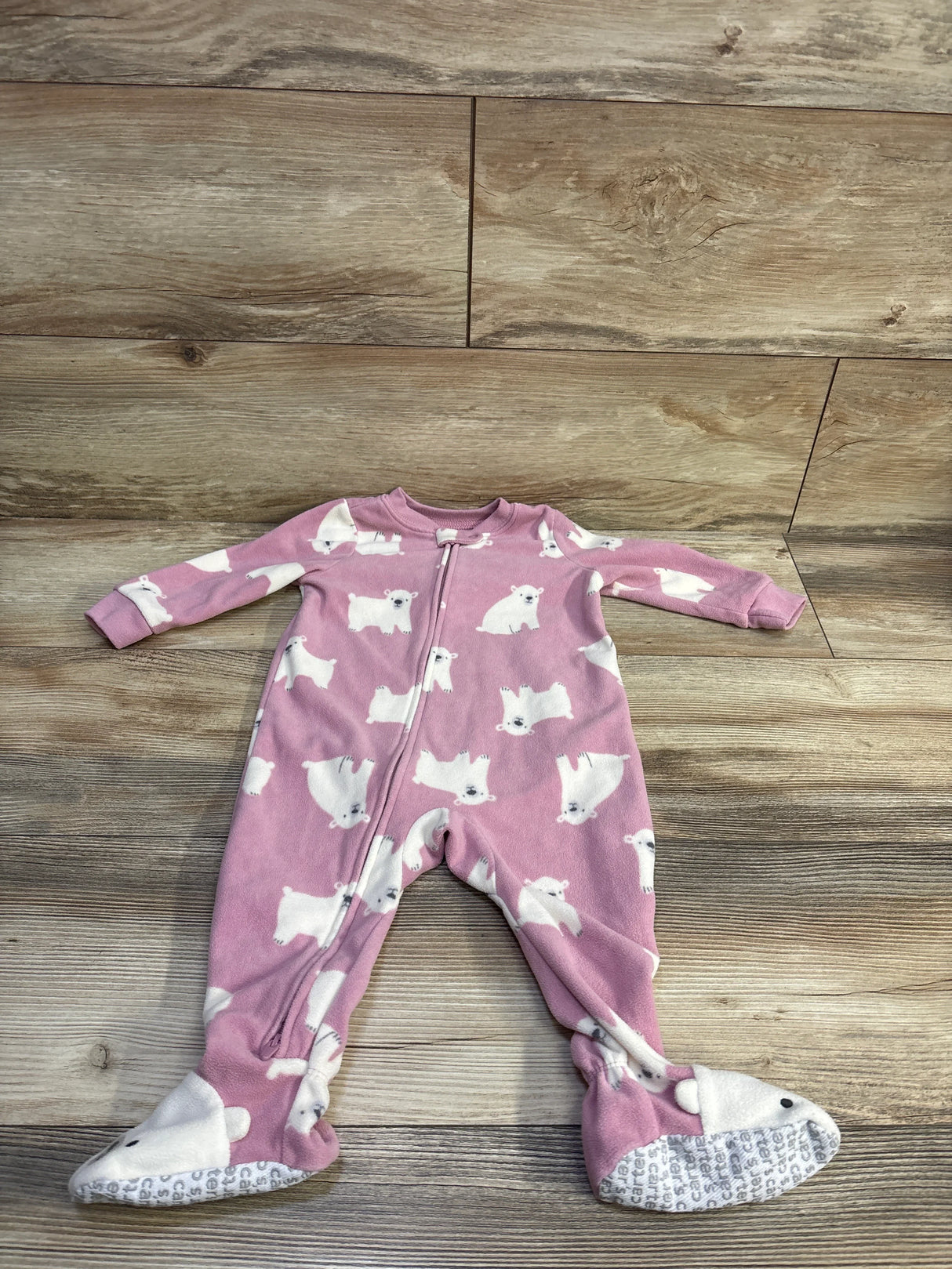 Front view of Carter’s pink footed sleeper size 12 months showing polar bear print, front zipper, and gripper soles