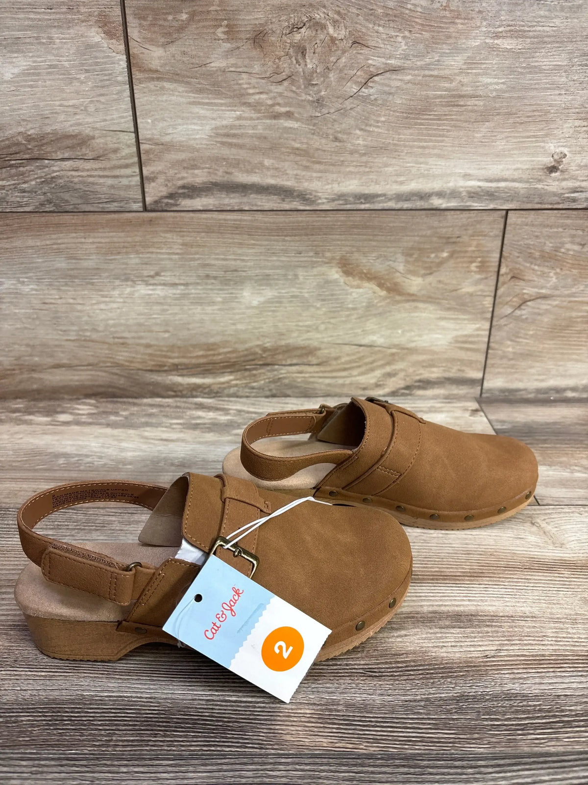 Cat & Jack toddler girl's size 2 brown faux suede clogs with ankle strap on wood floor background