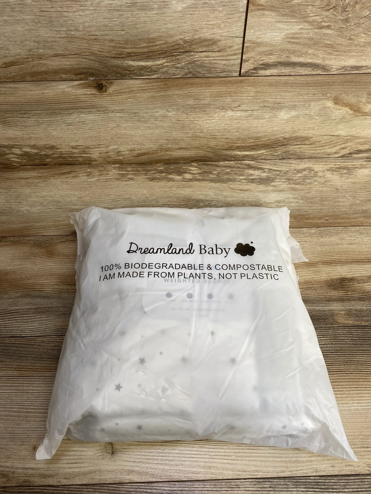 Dreamland Baby biodegradable and compostable packaging made from plants, not plastic, on wooden surface