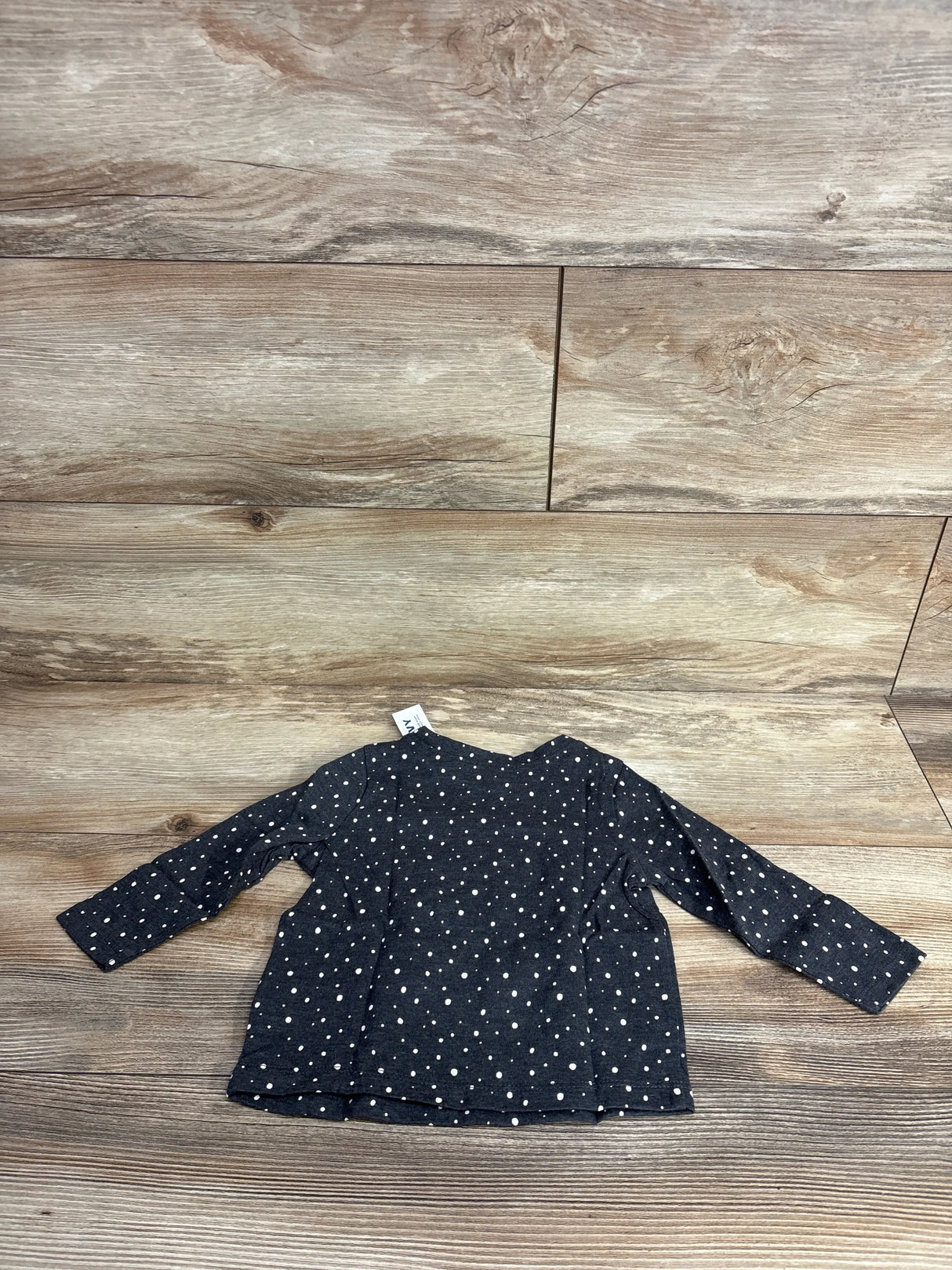 Back view of NWT Old Navy long sleeve polka dot shirt in dark charcoal with white dots on wood plank floor