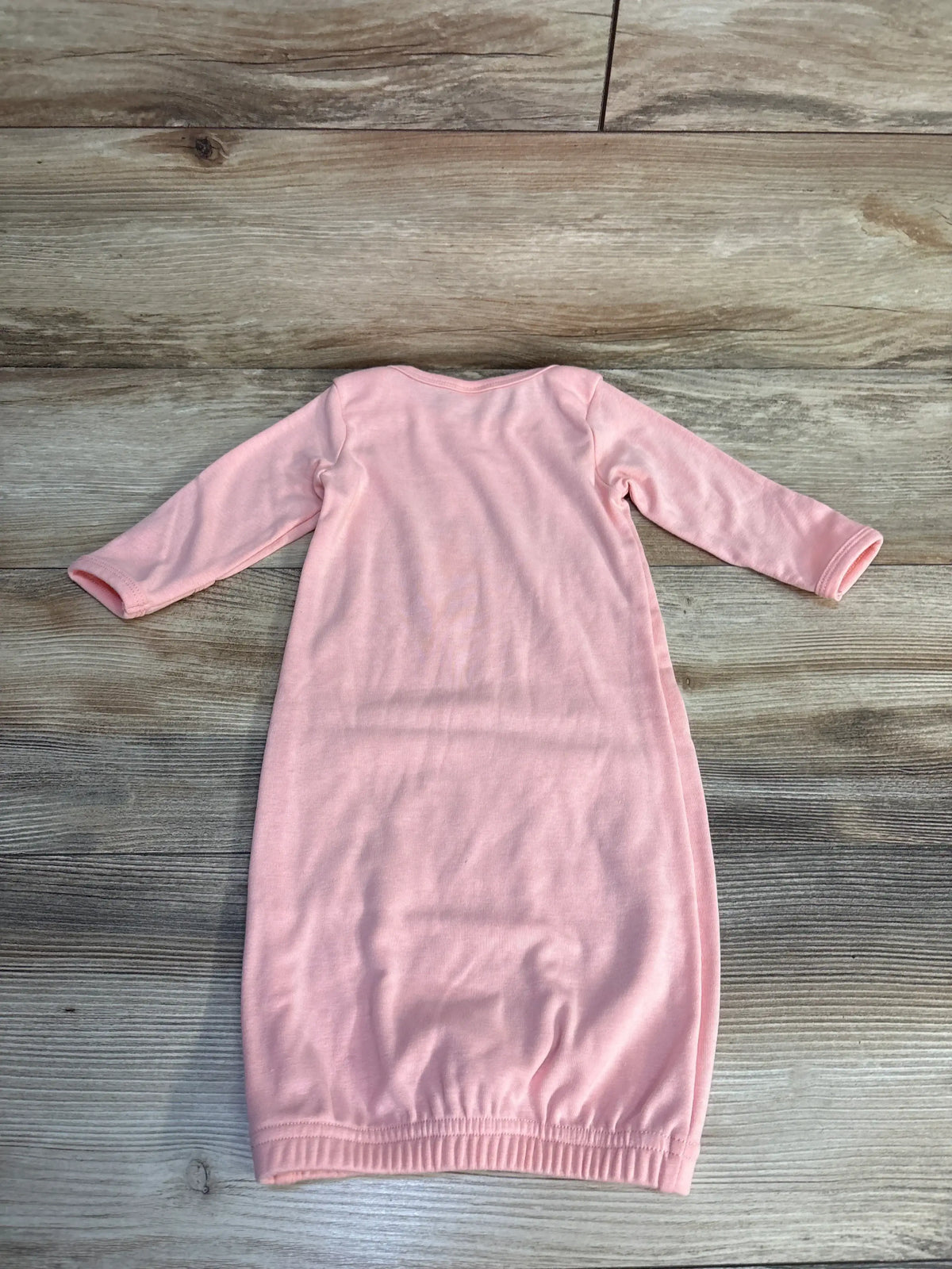 Pink long sleeve baby gown on wood floor, soft cotton newborn sleepwear