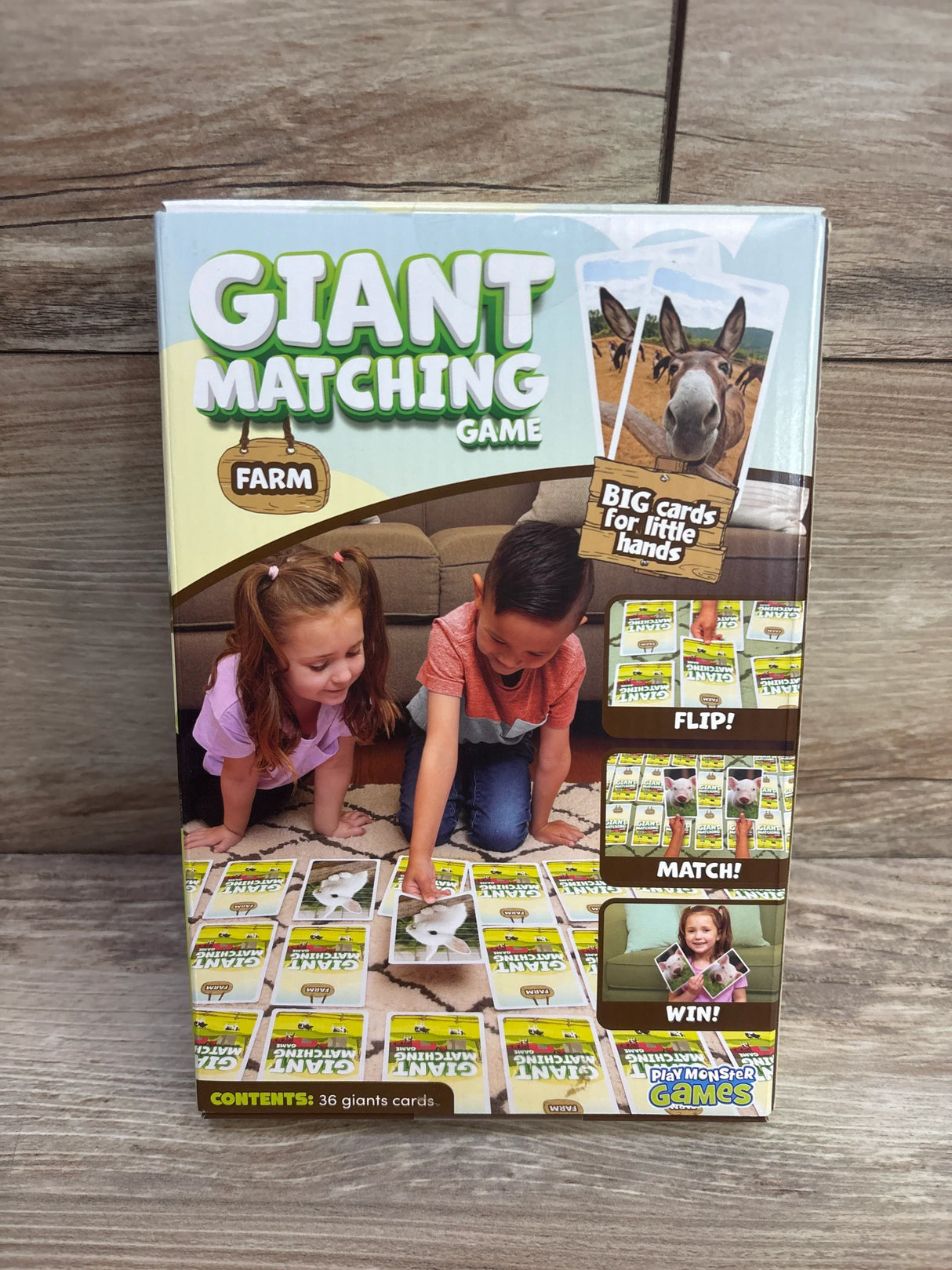 Front view of PlayMonster Giant Matching Game Farm box showing headline 'GIANT MATCHING GAME', kids playing, and 'BIG cards for little hands' on wood floor