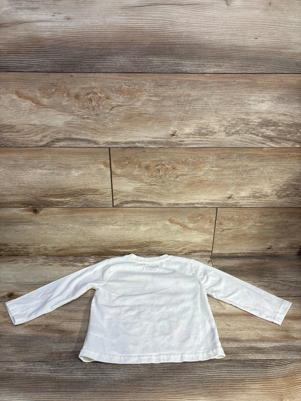 Back view of Nickelodeon PAW Patrol Shirt White sz 3T showing long sleeves and relaxed fit on a wood surface