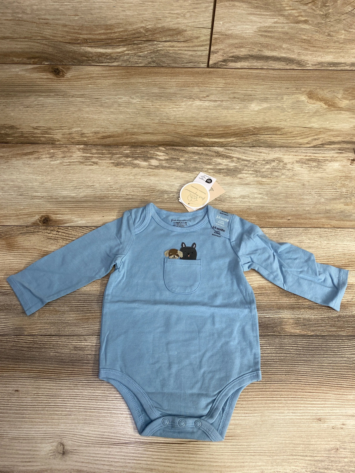Blue long-sleeve baby bodysuit with pocket featuring cute puppy and black cat designs
