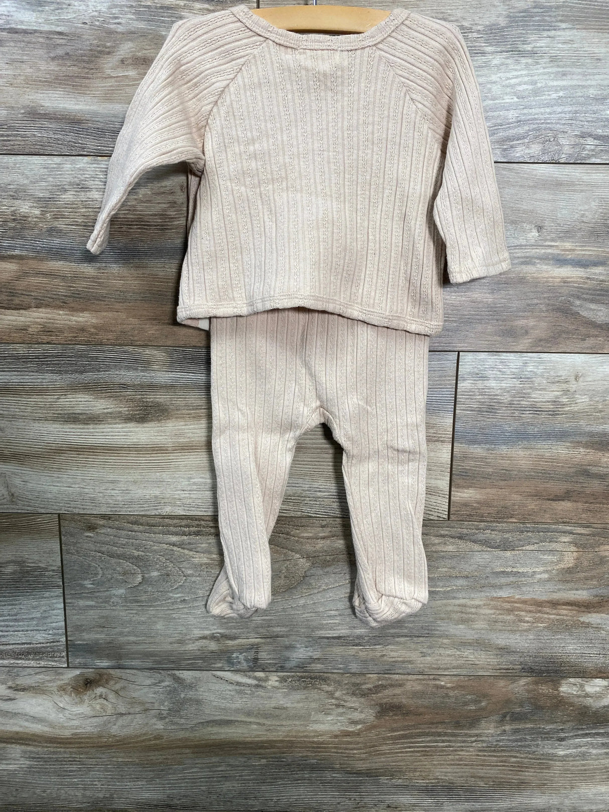 Front view of baby kimono shirt and footed pants set in beige showing ribbed knit texture on wood background