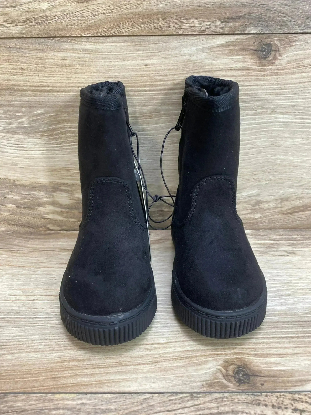 Front view of Cat & Jack toddler black shearling-style zipper boots showing faux-suede upper, faux-fur collar and ribbed rubber sole on wood background