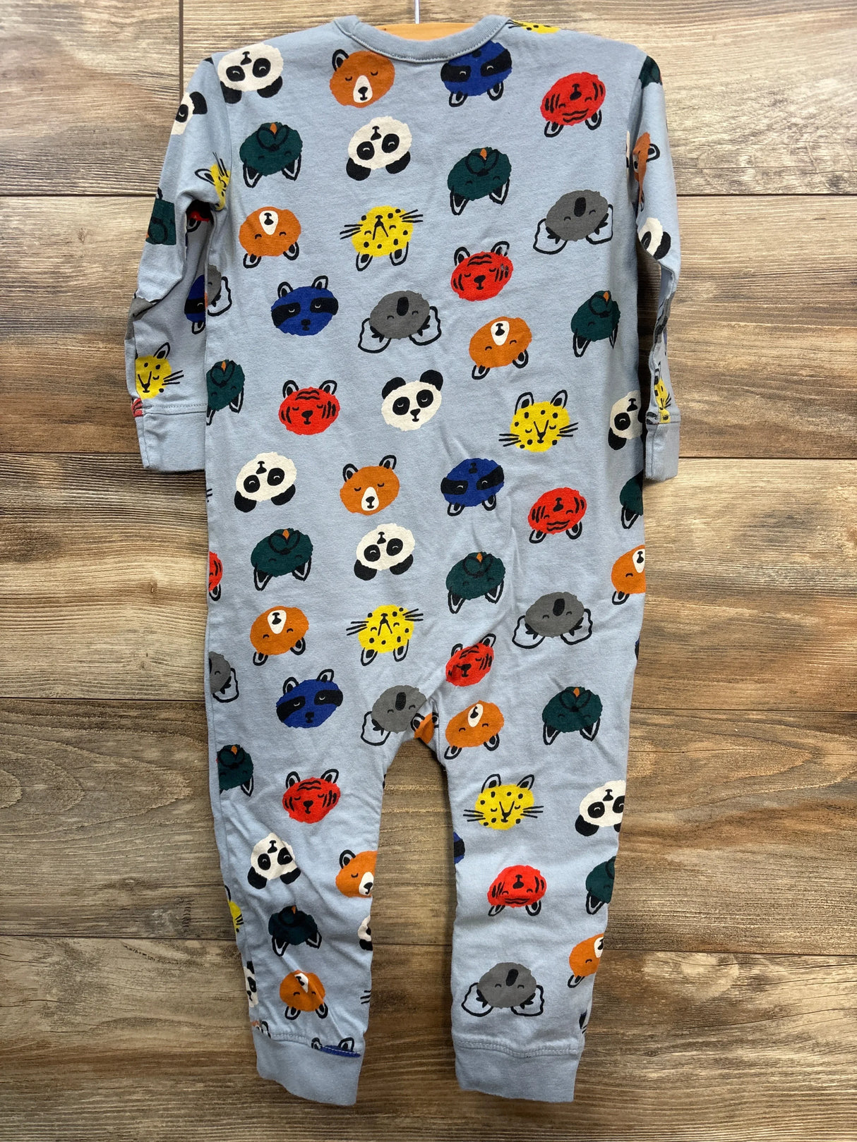 Gray baby romper with colorful animal face print, long sleeves, laid flat on wood floor