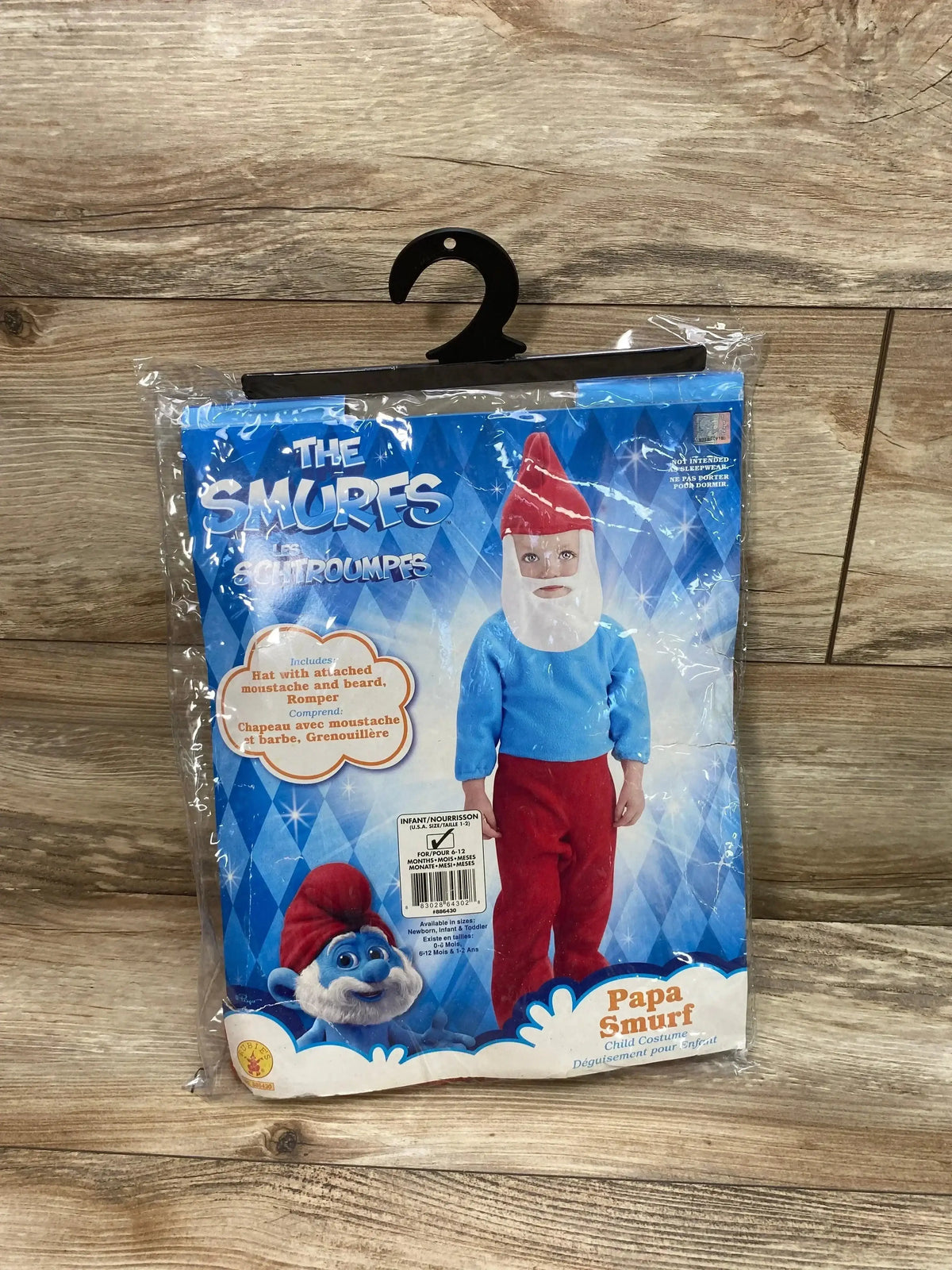 Front view of Rubie’s Papa Smurf costume package with blue top, red pants, beard and hat, plus The Smurfs and Papa Smurf text
