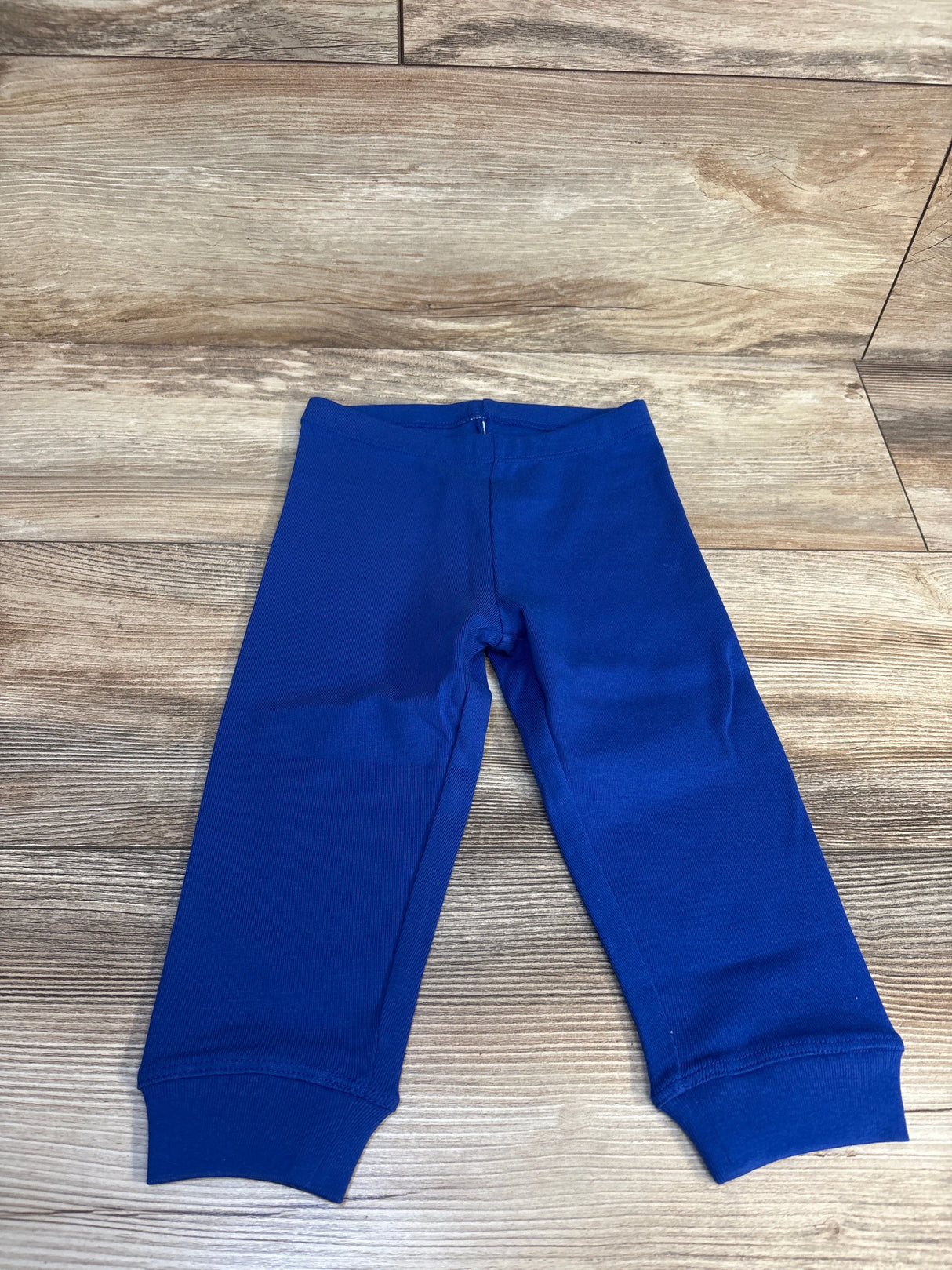 Blue toddler leggings on wood floor, kids clothing resale, gently used pants