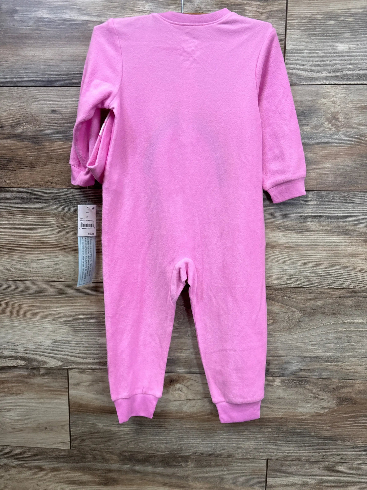 Flat lay of NEW Care Bears 2pc Hat & Sleeper Set Pink sz 2T showing pink long sleeves and ribbed cuffs on a wooden background
