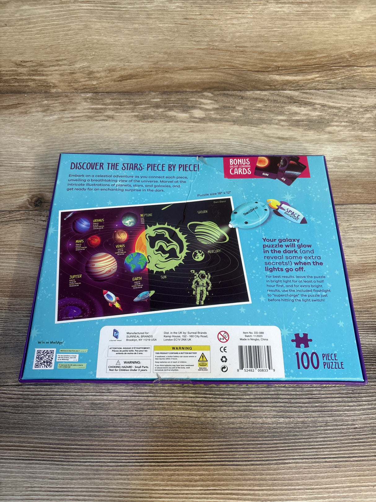100 piece glow in the dark solar system puzzle box with planets, astronaut, and galaxy illustration