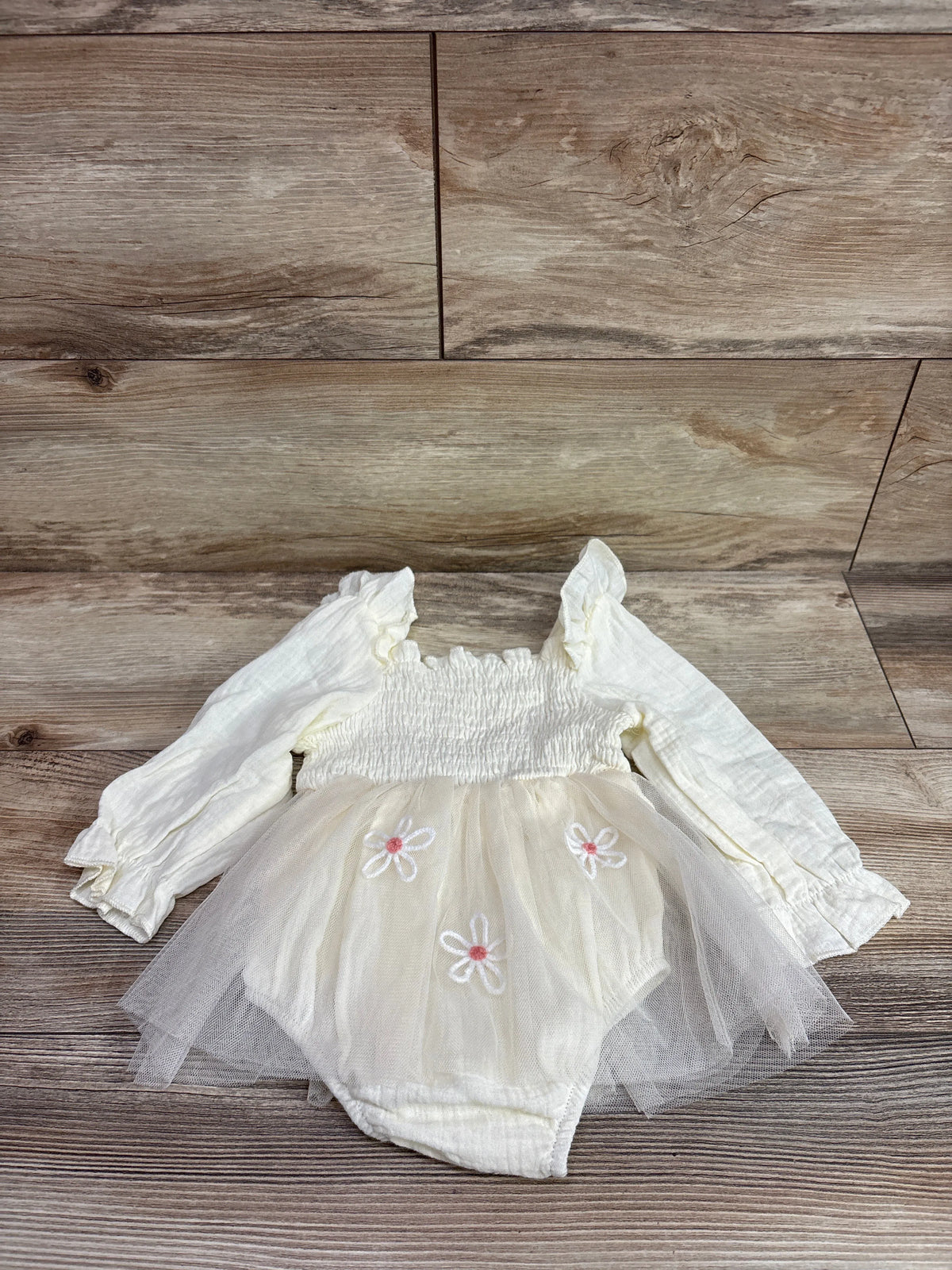 Front view of cream IMEKIS 1st birthday tulle romper showcasing smocked bodice, long sleeves, floral details, and bloomers
