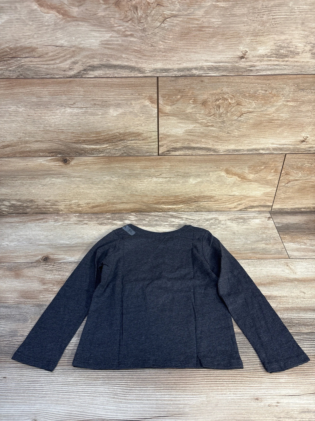 Back view of Children’s Place grey toddler long-sleeve shirt size 3T showing plain back on wood background