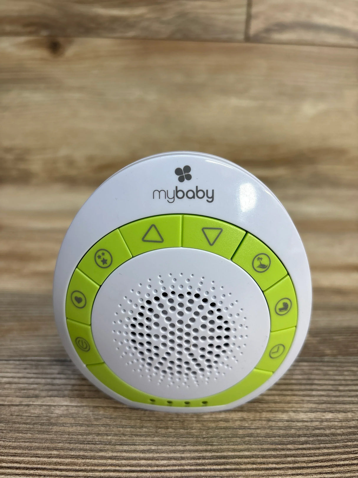 mybaby white and green baby sound machine with control buttons on wood surface