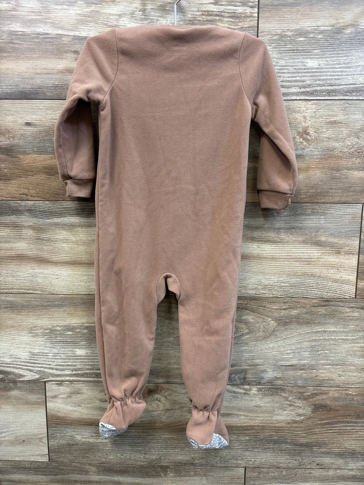 Back view of Carter’s brown walrus blanket sleeper in size 2T showcasing footed legs and long sleeves on a wood plank background