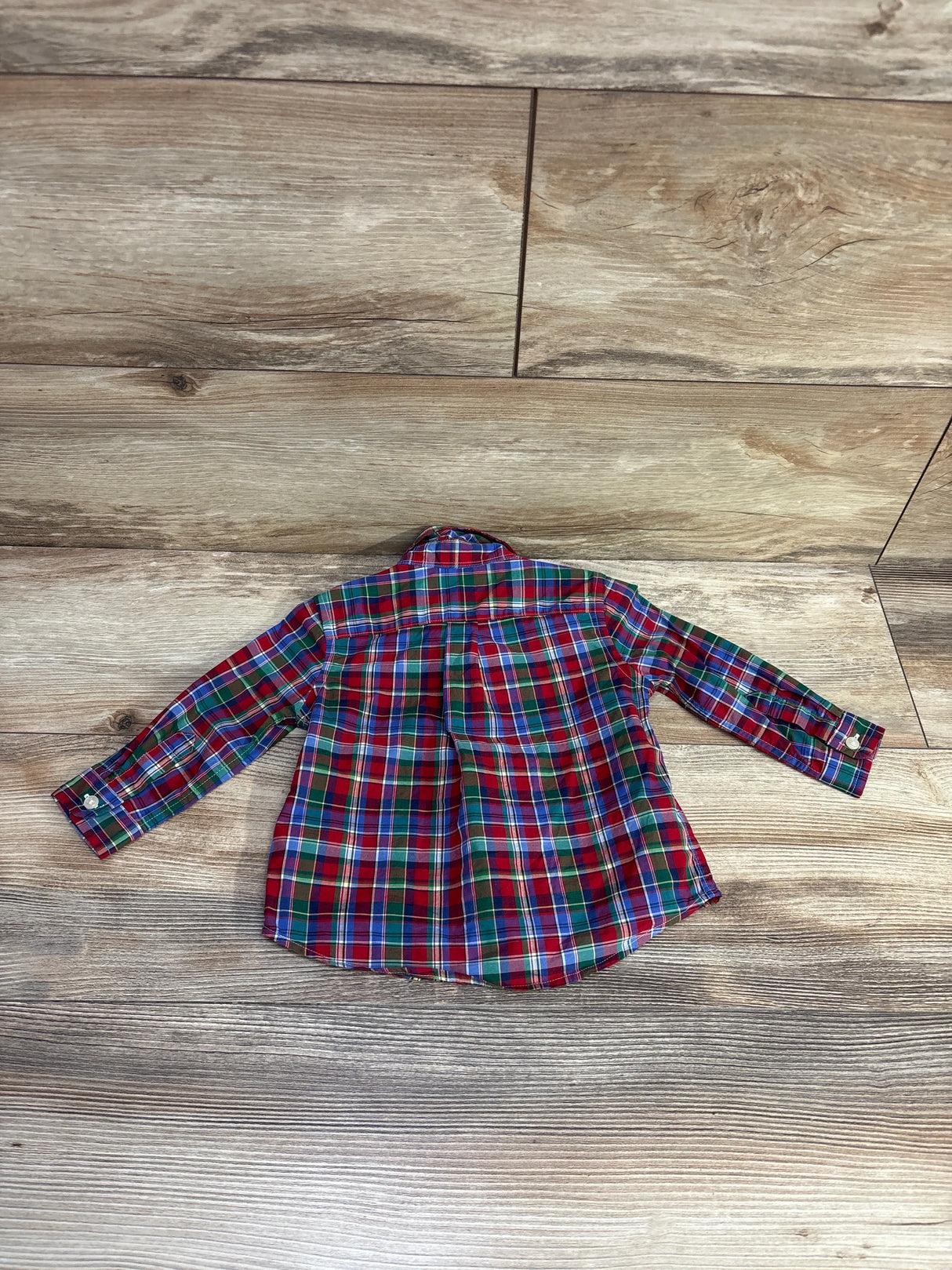 Kids red green blue plaid long sleeve shirt on wood floor