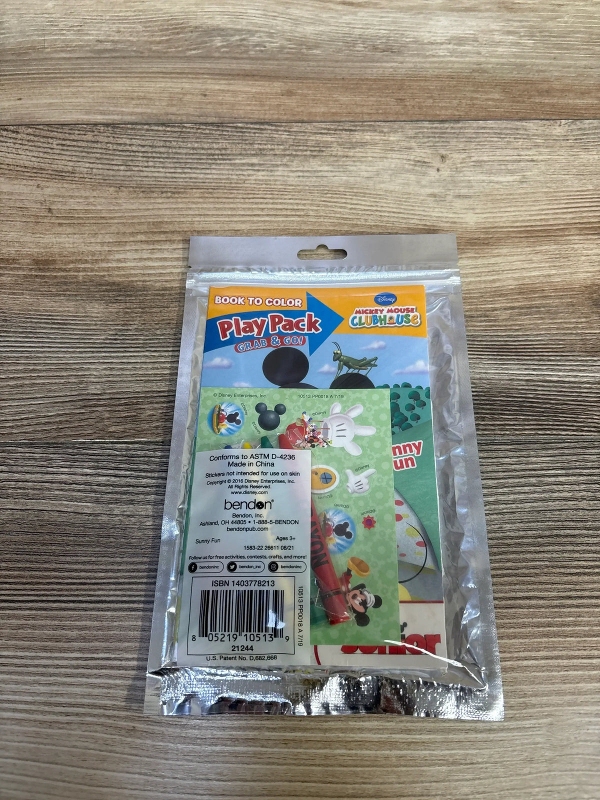 Back of NEW Mickey Mouse Clubhouse Play Pack Grab and Go Fun Size Coloring Book Set in sealed retail bag on wood plank floor