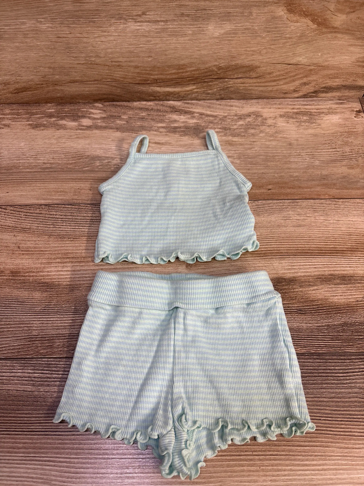 Baby Gap light blue ribbed tank top and shorts set with ruffle trim on wood background