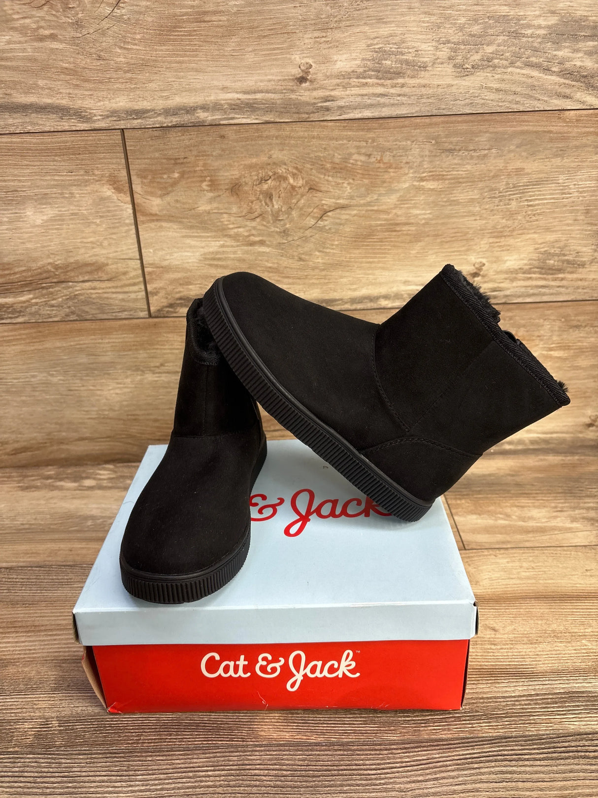 Black Cat & Jack kids winter boots with faux fur lining on branded shoebox on wood surface