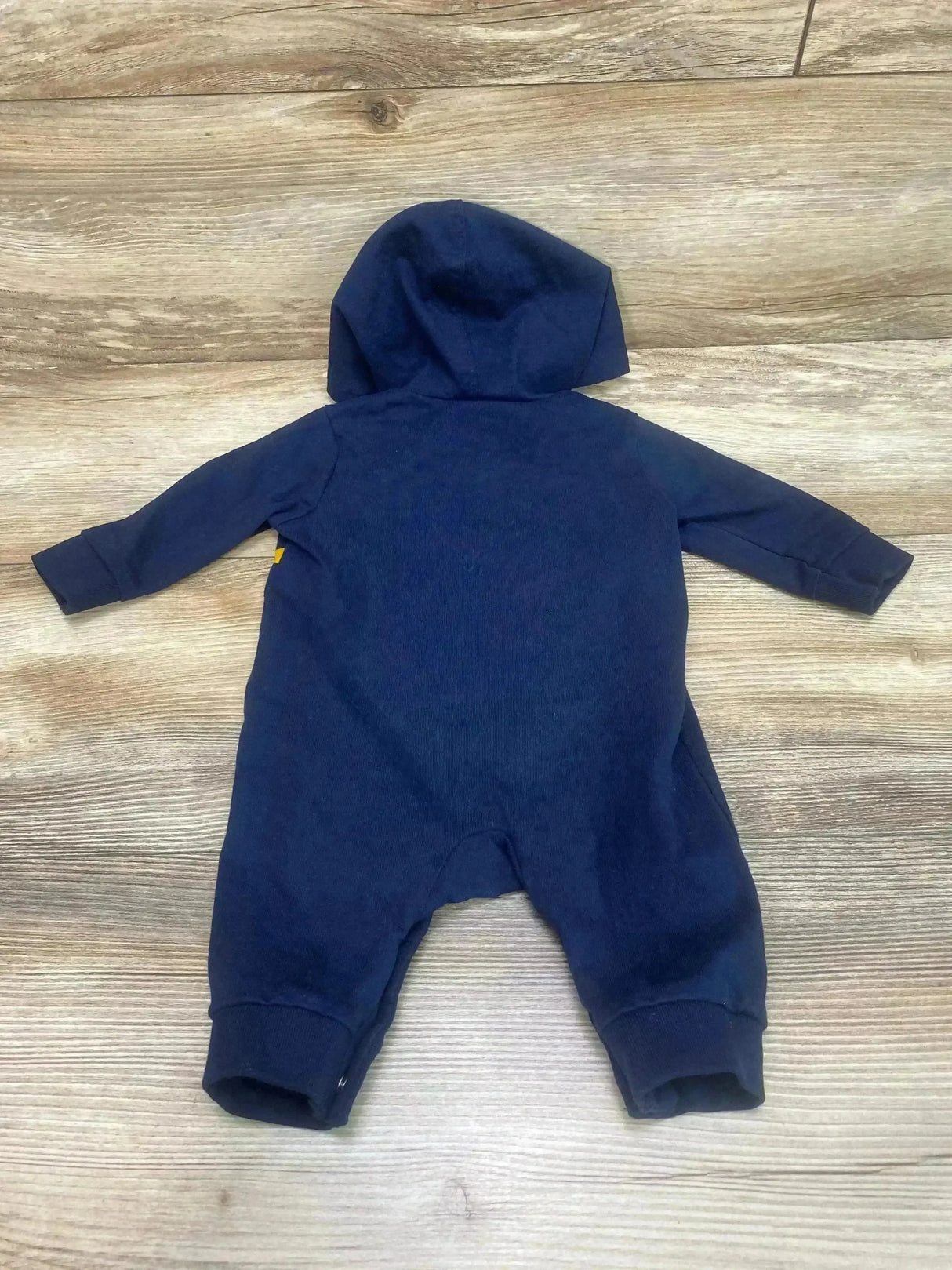 Back view of Old Navy striped hooded coverall, size 0-3m, showing hood, long sleeves and ribbed cuffs on a wood floor background