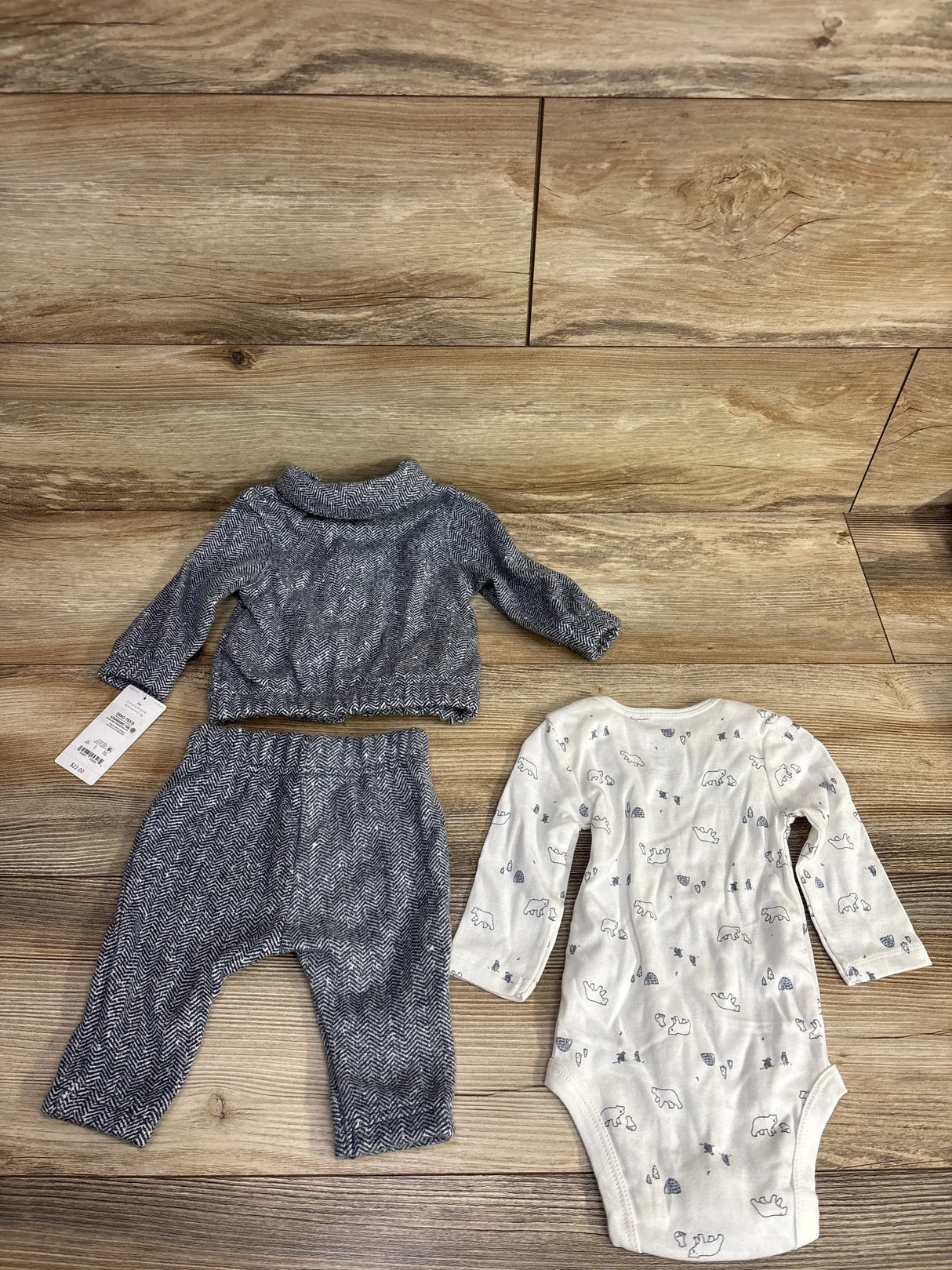 Baby outfit set with gray herringbone long sleeve top, matching pants, and white bear print onesie