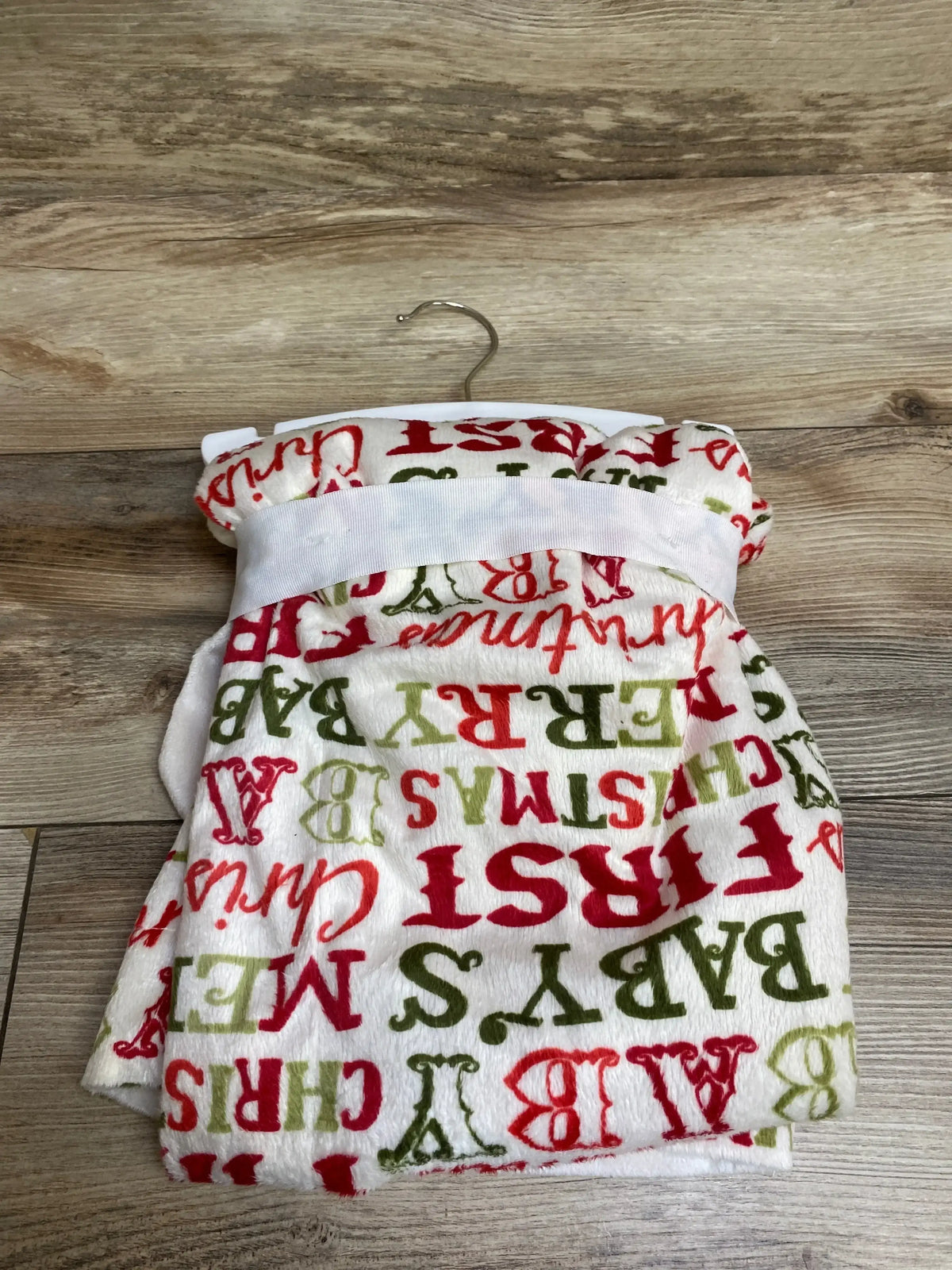 Baby's First Christmas red green print onesie on hanger, soft fleece holiday outfit for infants