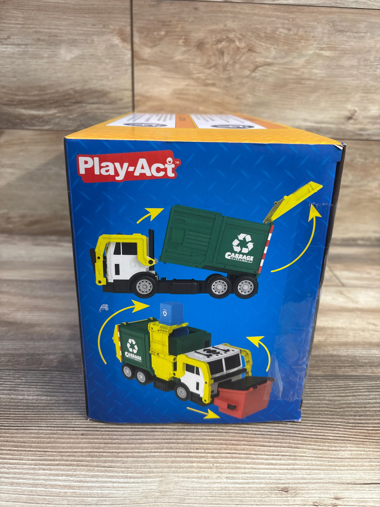 Front view of Joyfy Play-Act 16-inch garbage truck box showing tilting green dumpster and front loader on wooden backdrop