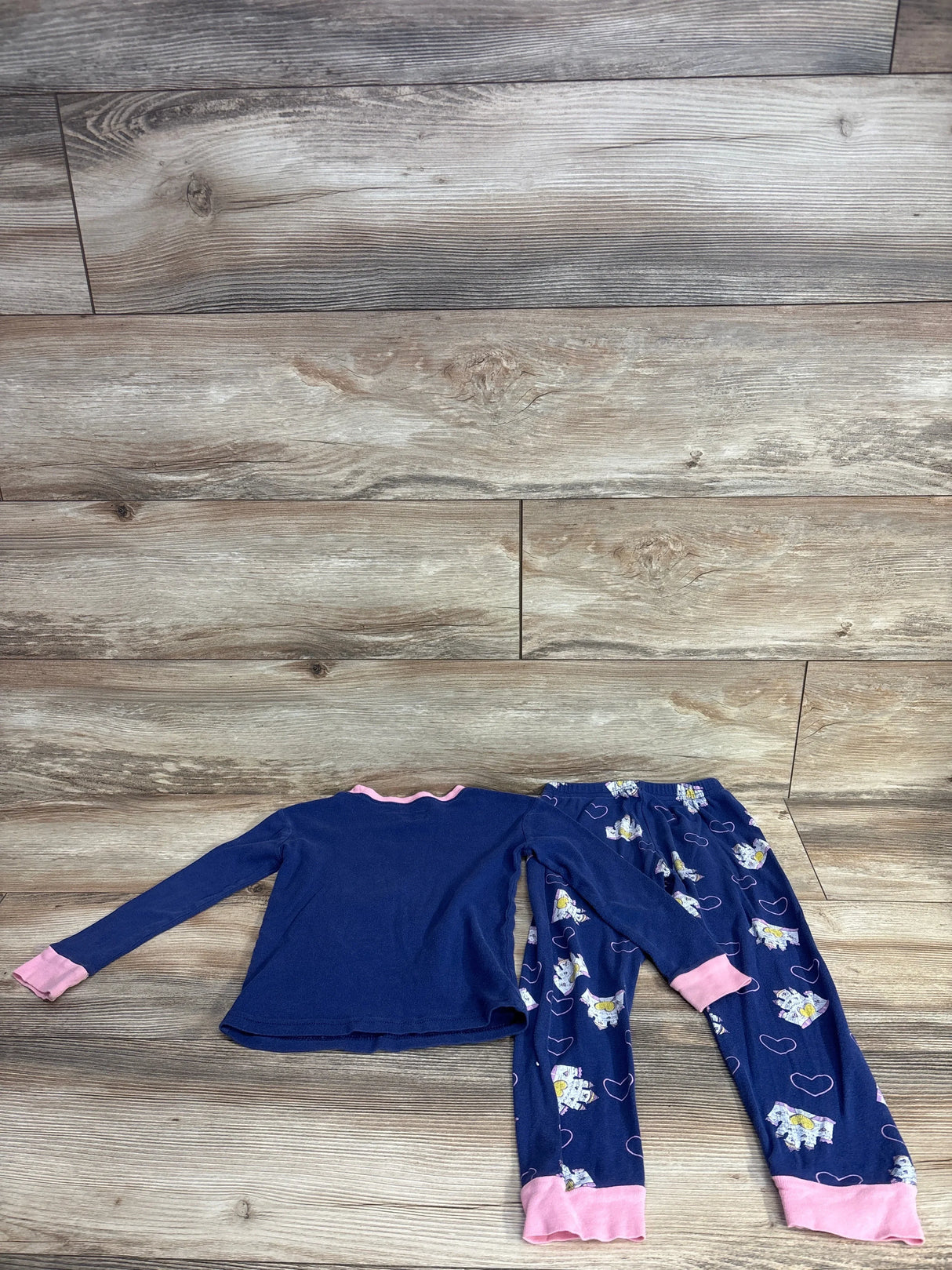 Children's navy blue long-sleeve top with pink cuffs and collar, matching pants with unicorn and heart print